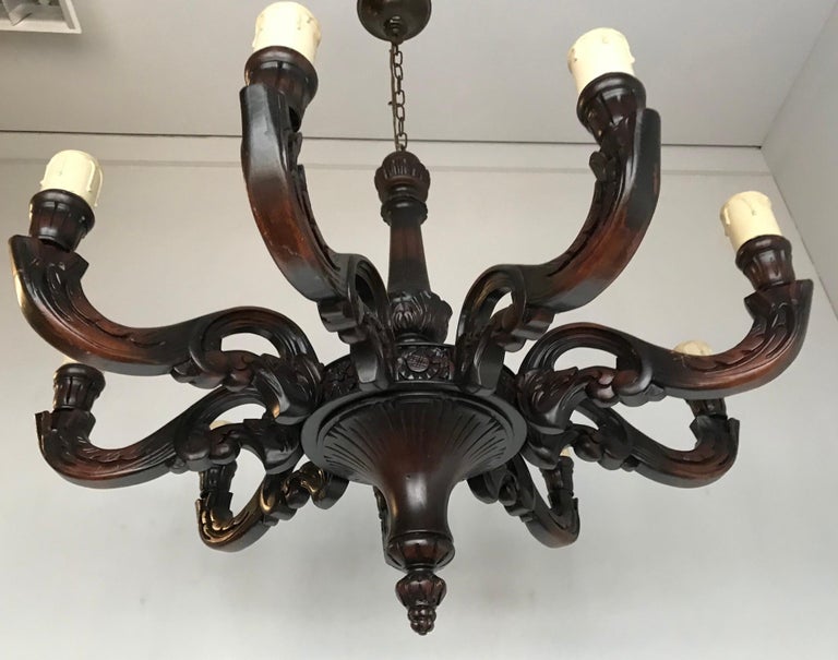 Handsome and well carved nine-light chandelier, from circa 1915.

If you are looking for a sizeable, classical wooden chandelier with a warm look and feel to create just the right atmosphere in your dining room then this fixture could be the one for