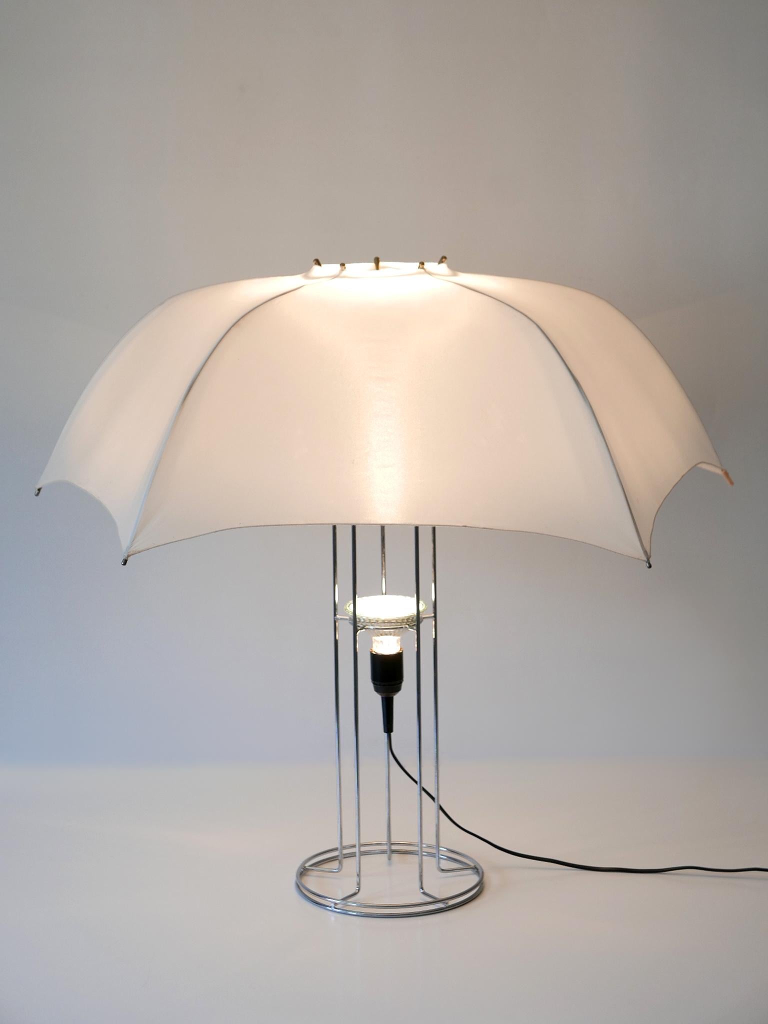 Large, rare and highly decorative Mid-Century Modern 'Umbrella' table lamp. Designed by Gijs Bakker in 1973. Manufactured by Artimeta, Netherlands, 1970s.

Executed in chrome-plated metal, plastic and fabric, the table lamp is executed with 1 x E27