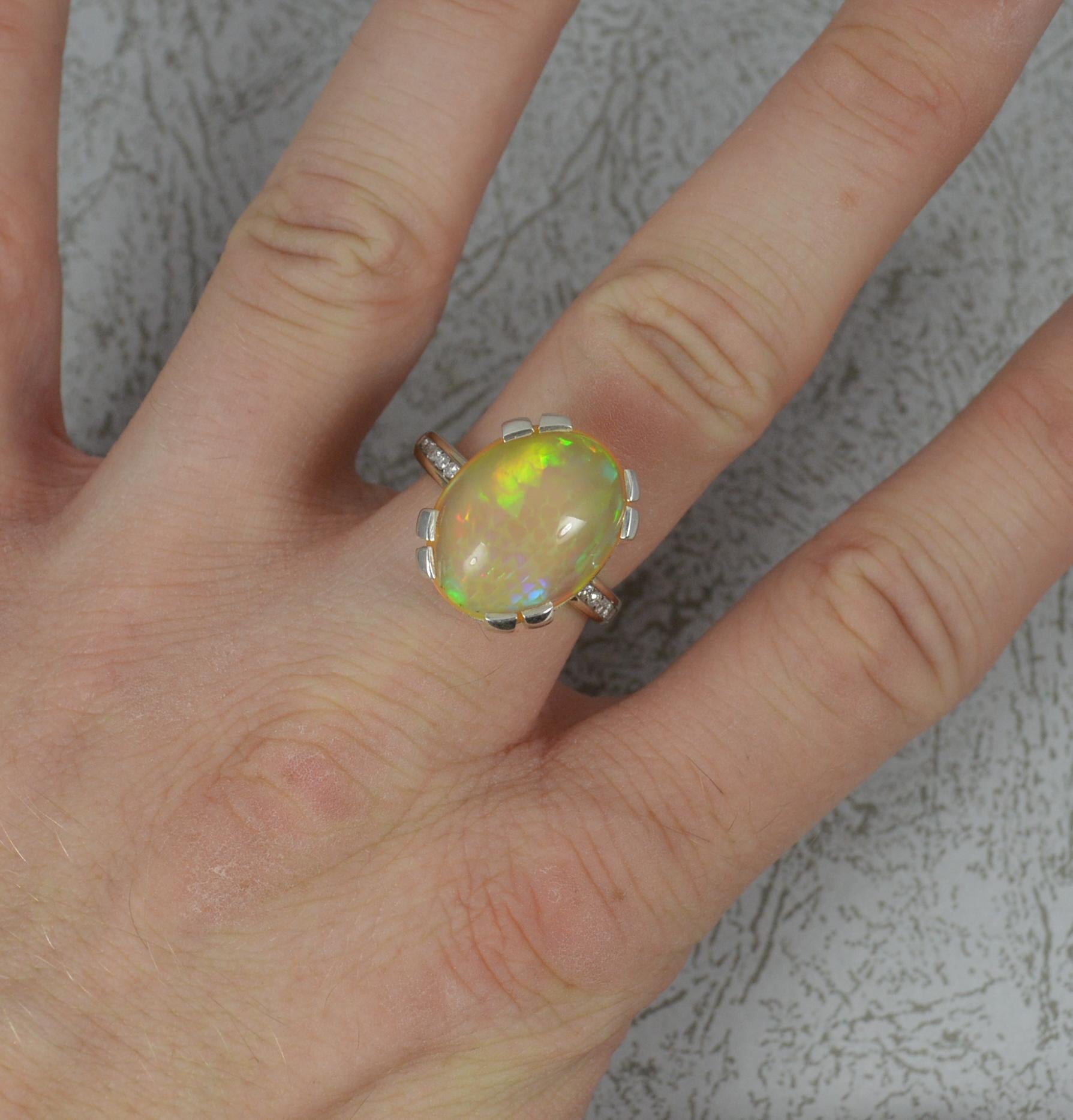 A beautiful vintage 18 carat gold, opal and diamond ring.
​The 18 carat white gold example.
Designed with a large oval shaped opal. 13mm x 17mm. Protruding 12.3mm off the finger. 
Set with six round cut diamonds to each shoulder. 

CONDITION ; Very