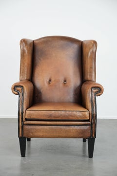 Large and comfortable sheepskin leather wingback chair with black piping