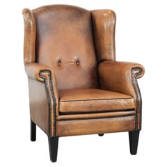 Large and comfortable sheepskin leather wingback chair with black piping