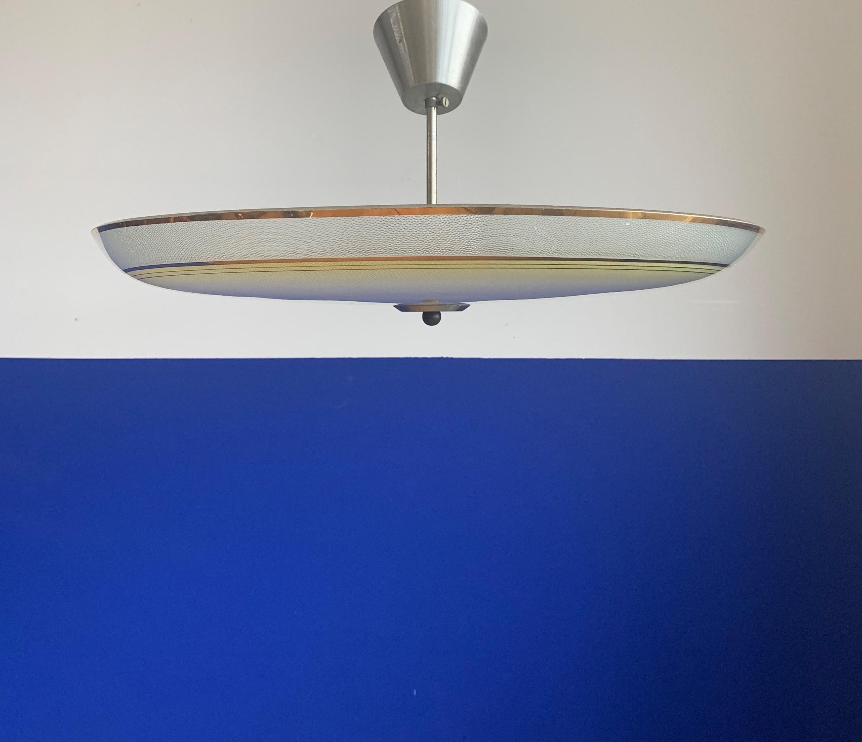 Impressive size and superb condition Mid-Century Modern ceiling lamp.

This good size light fixture has a beautiful look and feel and you will hardly ever find a light fixture from the Mid-Century Modern era with a larger and more stylish glass