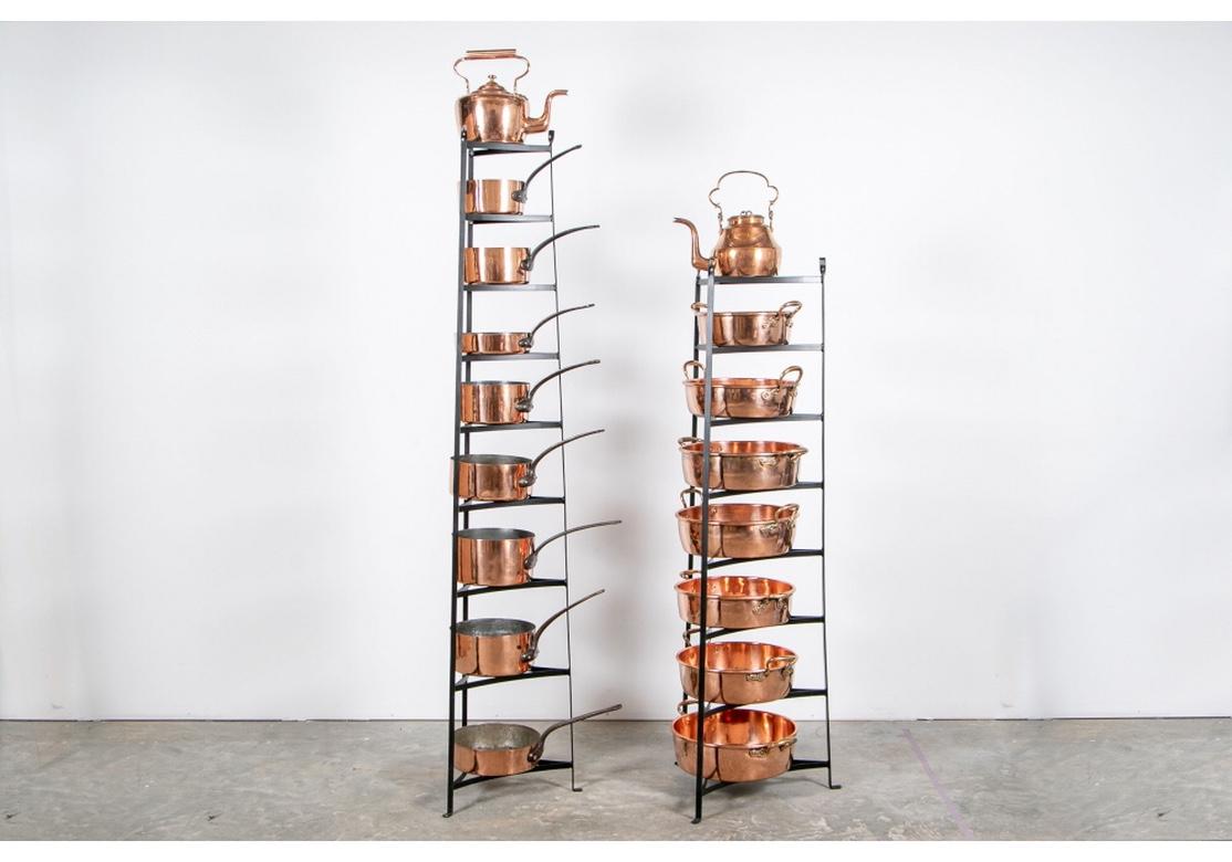 A notable collection of curated and collected antique copper pans, pots and teapot. All well-polished and clean with expected signs of age and use. The set includes:
two large tin lined teapots, one angular, largest H. 12 1/2