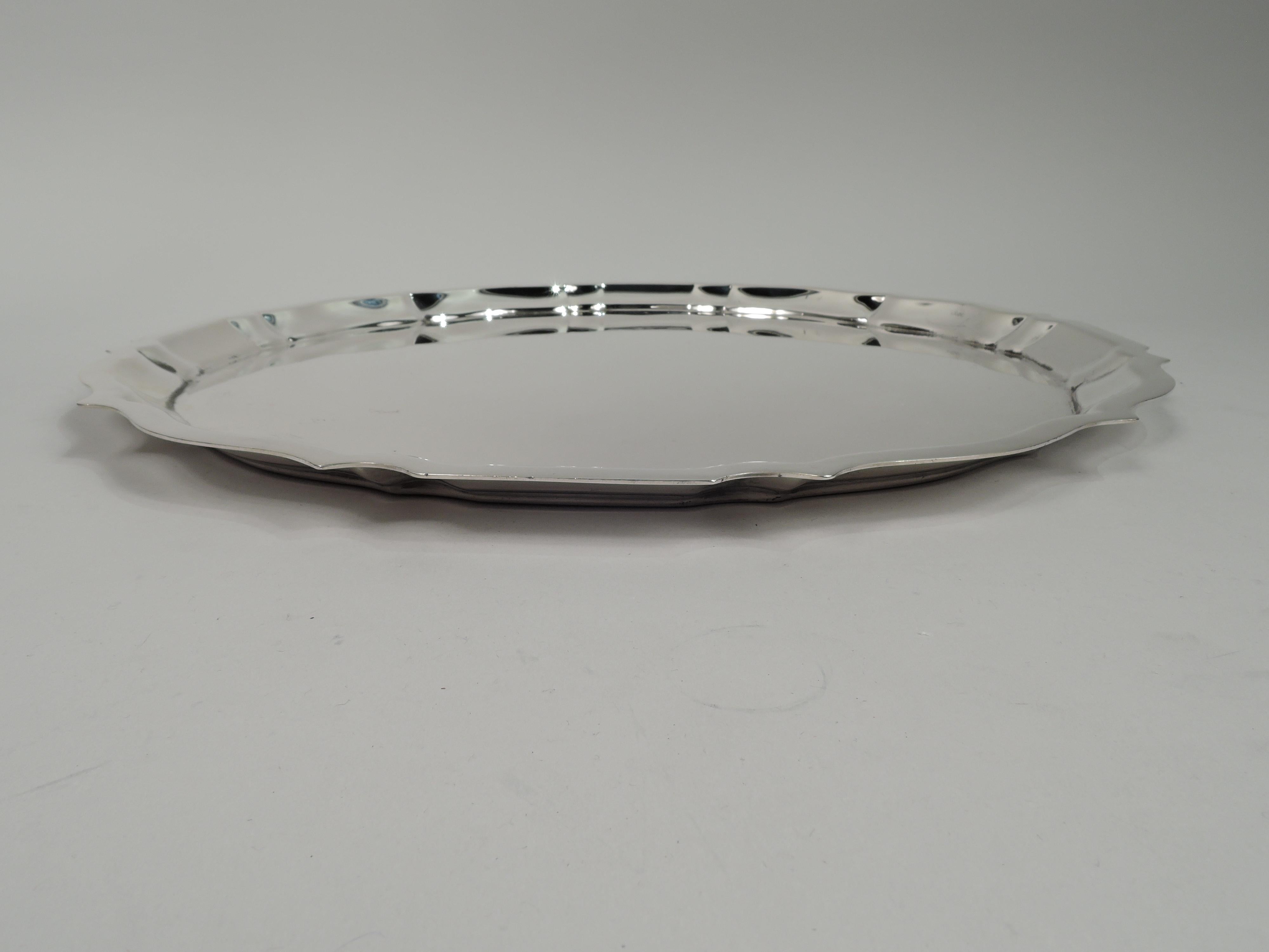 Chippendale sterling silver serving tray. Made by Gorham in Providence in 1944. Round with flat curvilinear ogee rim. A large and heavy piece in this pattern. Fully marked including maker’s stamp, no. 42613, and date code. Weight: 38.4 troy ounces. 