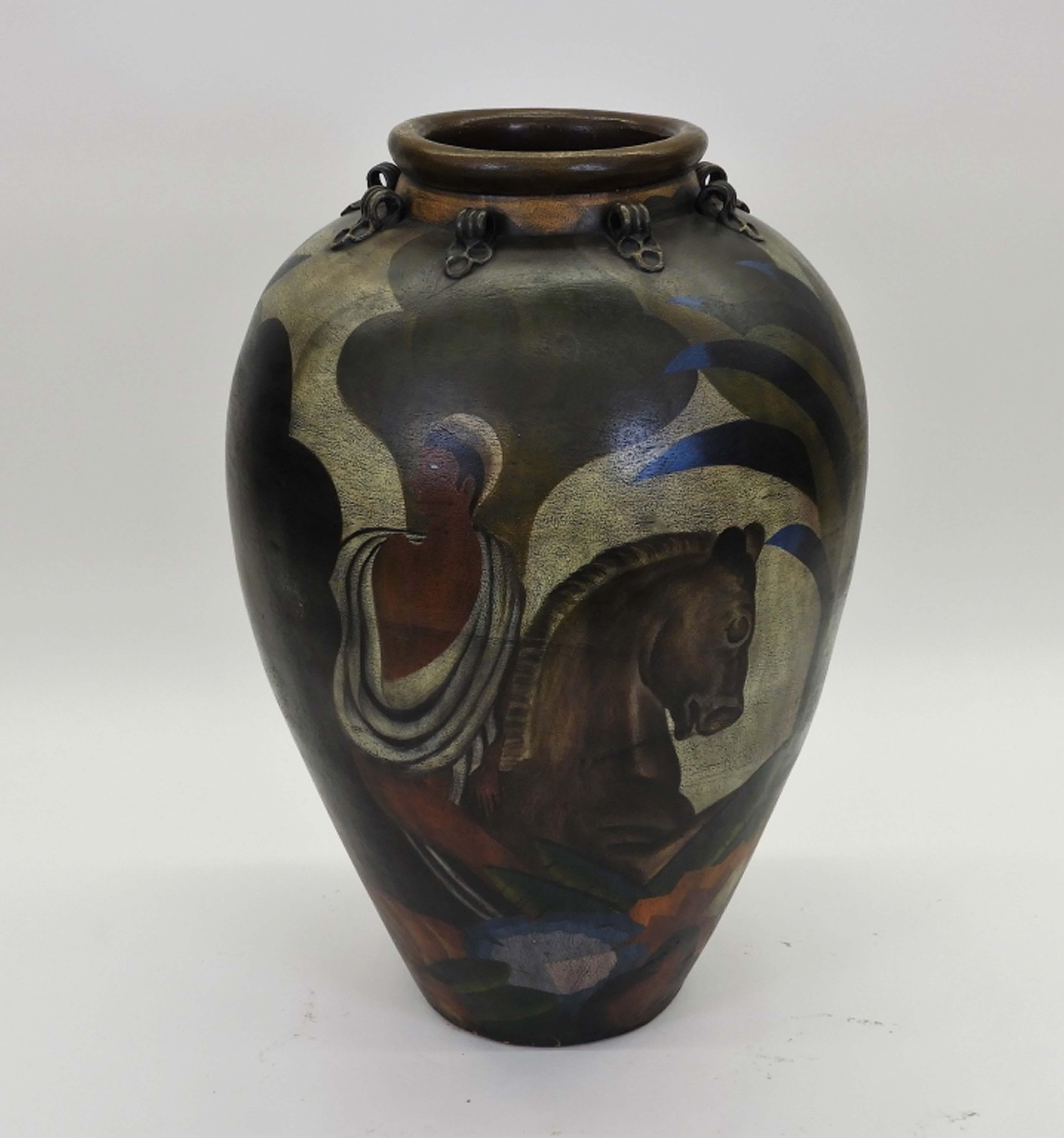 This is a massive and very heavy hand-made and hand-painted pottery vase created in the United States in the 20th century
It has a baluster form and is decorated with a landscape scene depicting a man riding a horse. 
Amazing technic to make a
