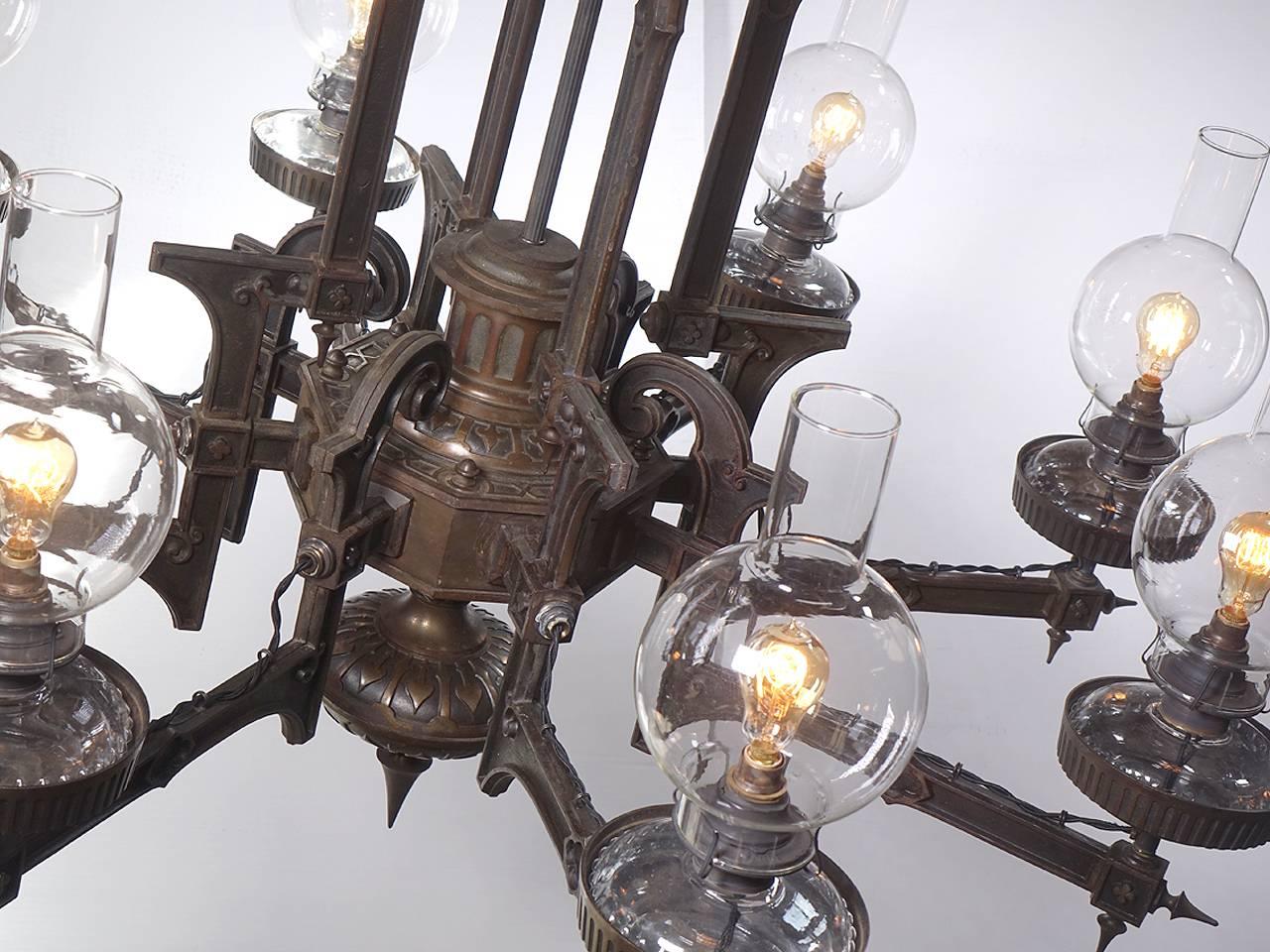Not many of these large and impressive oil chandeliers were made and few survive today. Lamps like this are often unsigned but are attributed to companies like Tucker or Bradley and Hubbard. Our best guess is 1870 by Tucker. A lamp like this was