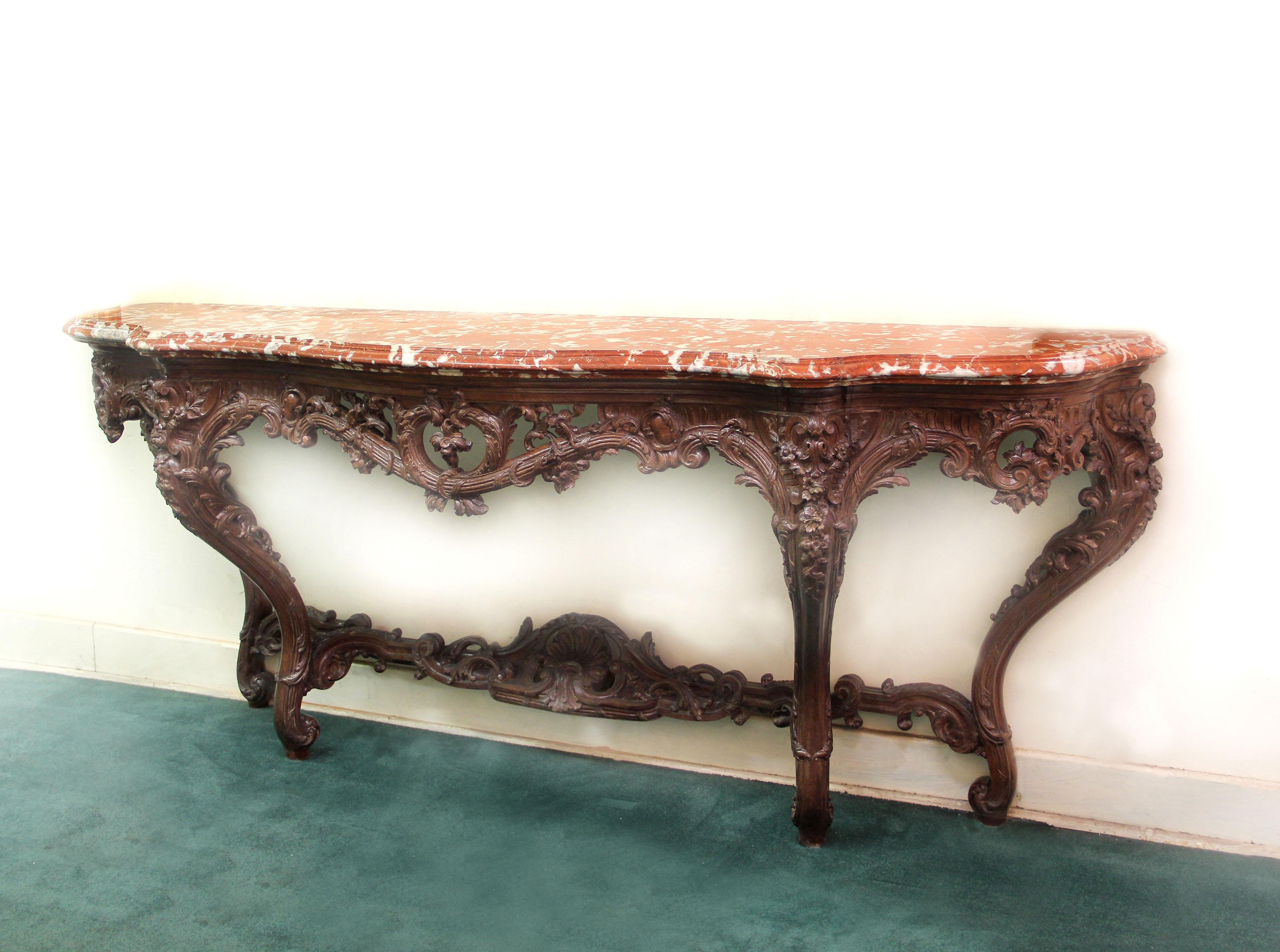 A Large and Important Late 19th Century Louis XV Style Carved Oak Console


A thick molded Rouge de Maine marble top above hand carved flower petals and acanthus leaves. The bottom stretcher is centered with a sea shell.

Stamped Gaumeloose to the