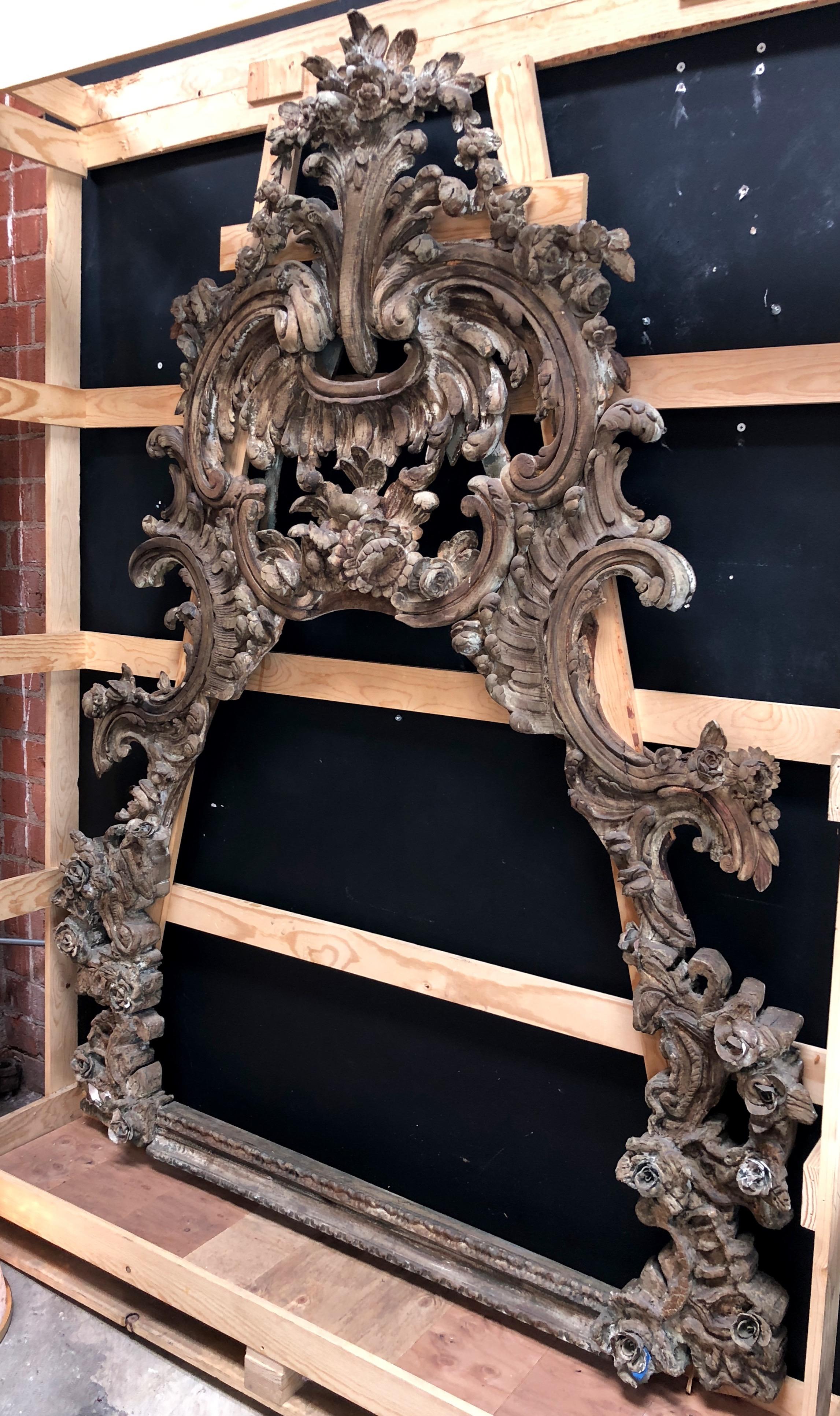 This beautiful antique frame is notable for its extremely fine hand-carved Baroque style detailing. 
Floral garlands and scrolling flowers imagery are common to Baroque design, as is the use of heavy textiles such as velvet and damask.
