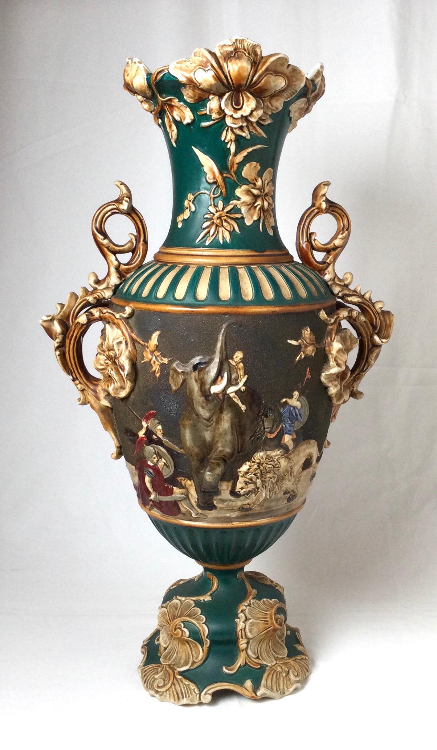 Bohemian Amphora large vase by Wilhelm Shiller and Sons featuring lions, elephants, soldiers with floral accents in vibrant colors. Marked WSS.
