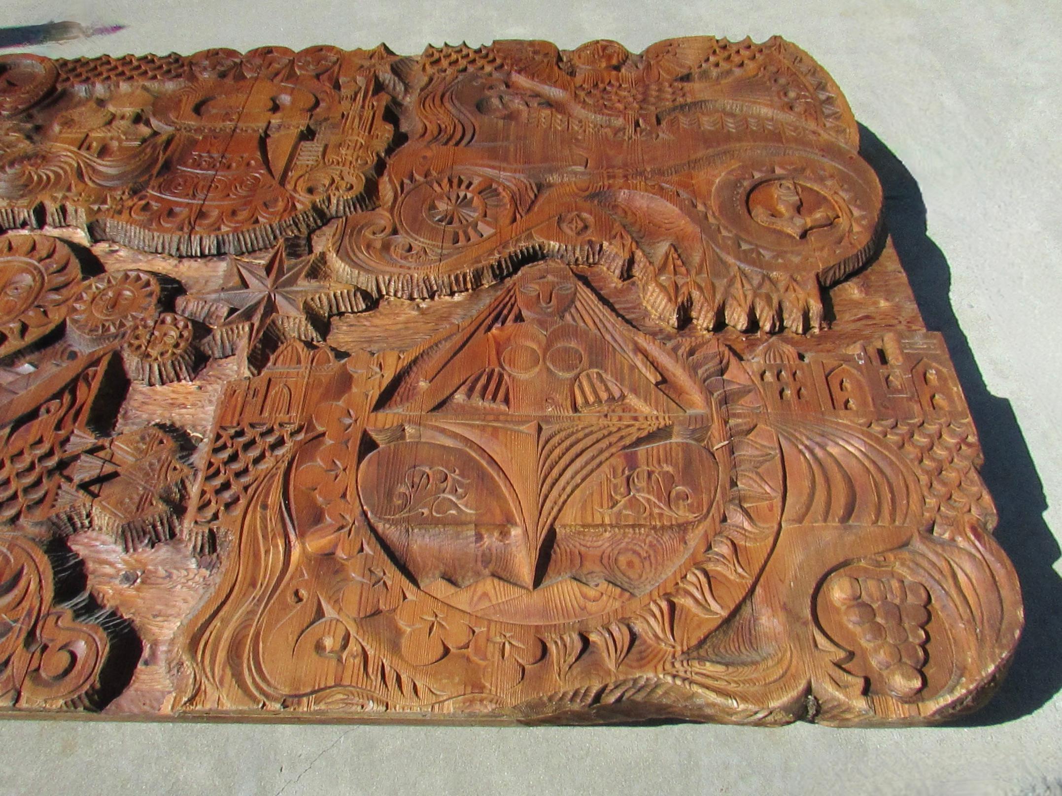 Large impressive Eastern European Folk Art carved Cedar panel. Large panel feature mythical creatures and symbols. Mermaids, Sirens, anchors, Sun Muscovite style buildings. Carving is mounted on stacked pieces of pine or Cedar . The panel is large