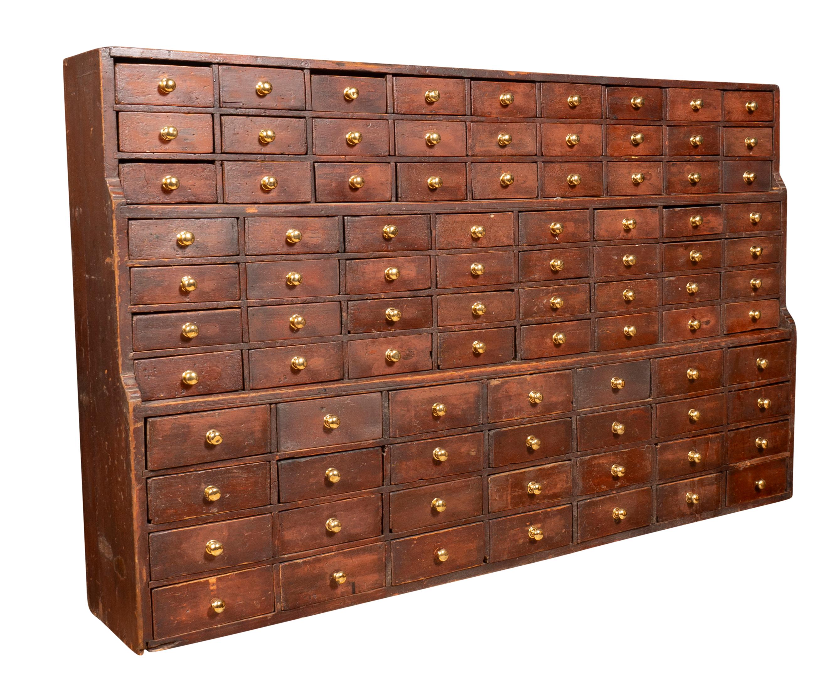 Having 87 drawers with brass knobs. Once used in a general store or apothecary. Shallow proportions.