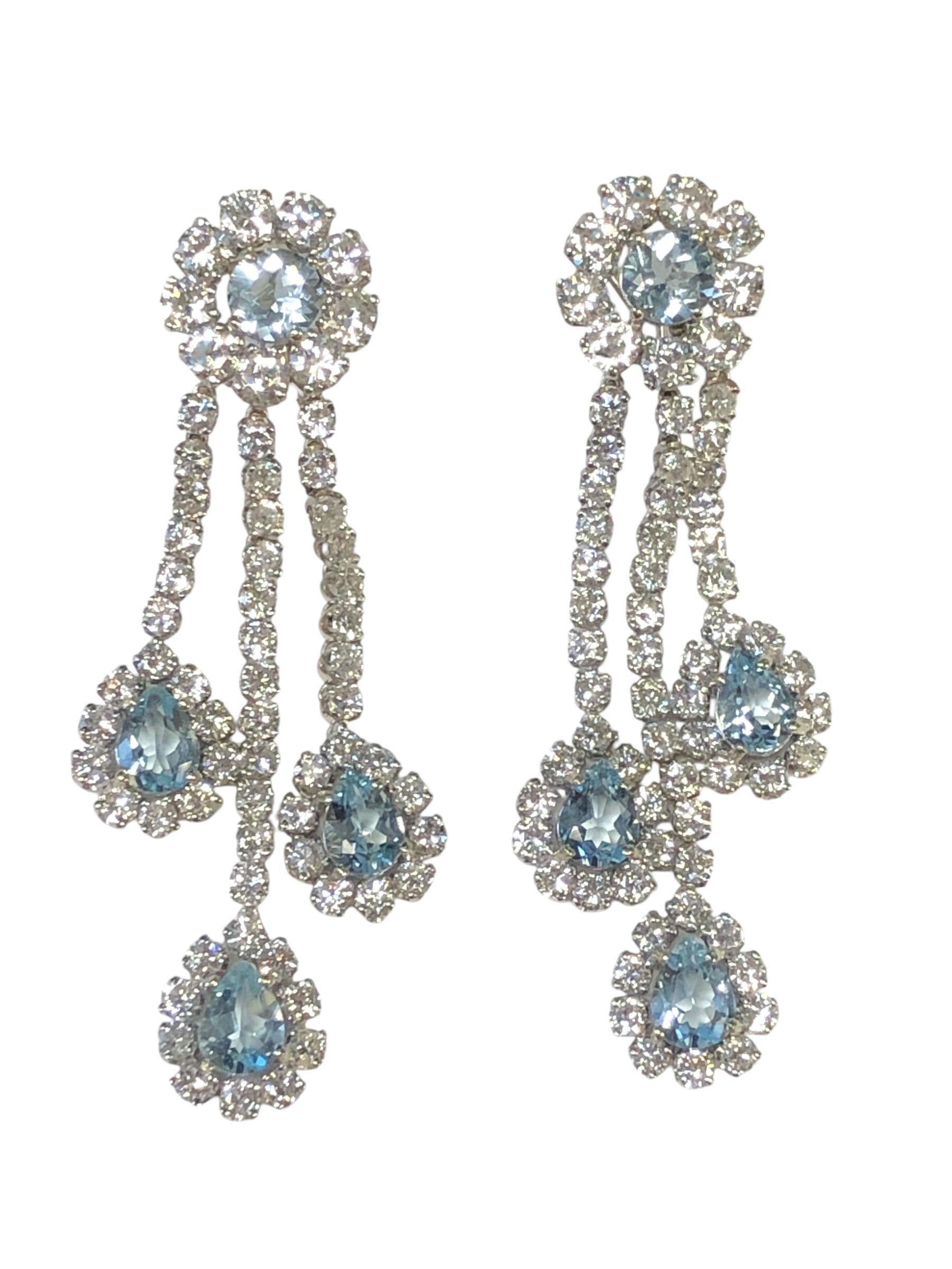 Circa 1990 White Gold Chandelier Earrings, measuring 3 inches in length and 1 inch wide with each part being individually attached for great articulation. Set with Round Brilliant cut Diamonds totaling 14 Carats and grading on the average as H in