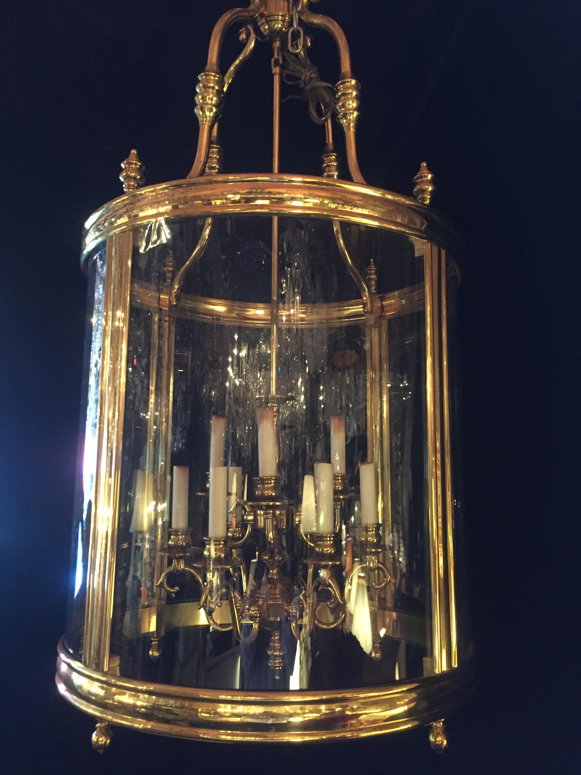 A large and massive fine French Louis XVI style gilt brass and curved glass multi light lantern chandelier.