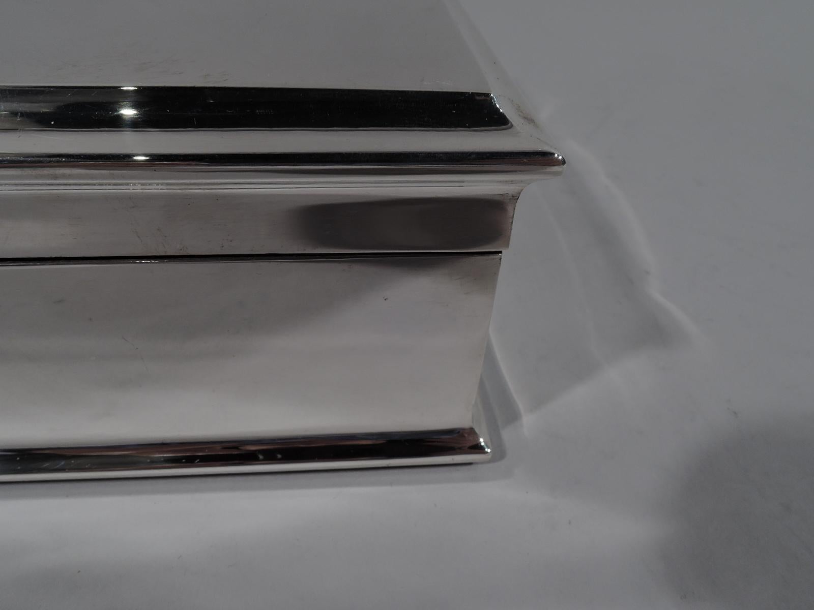 Large and modern English sterling silver box large and modern sterling silver box. Made by Adie Bros. In Birmingham in 1954. Rectangular with spread base. Cover hinged, flat, and raised. Box and cover interior cedar lined and partitioned. Box