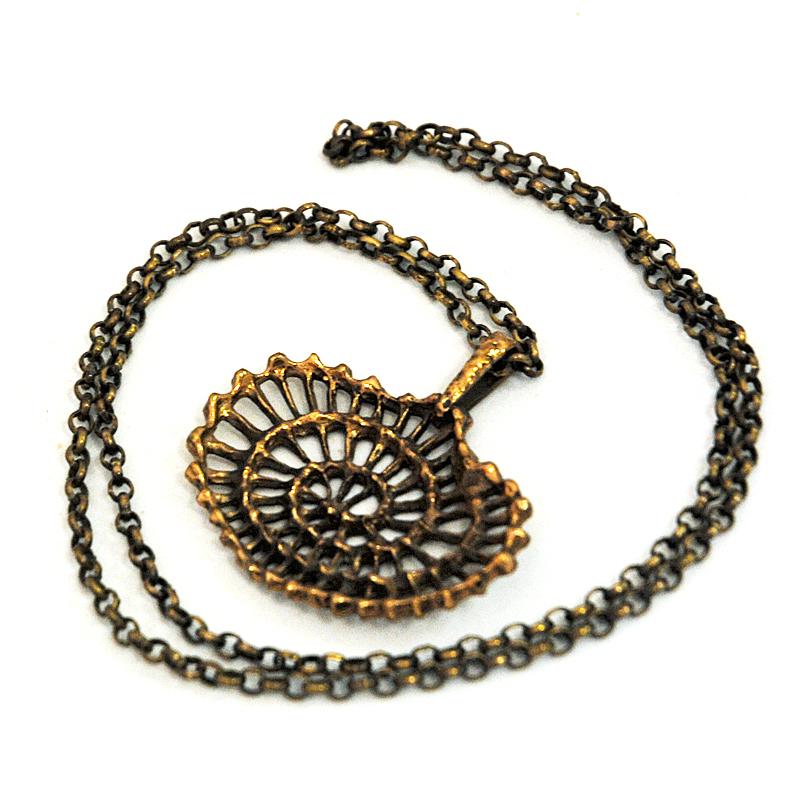 A large, oval and wonderful brutalist bronze necklace from the 1970s designed by K.E Palmberg for Alton, Sweden. Natural bronze patina with black patterns inbetween. Lovely circulating shell decor look pendant. Good vintage condition.

Measures: