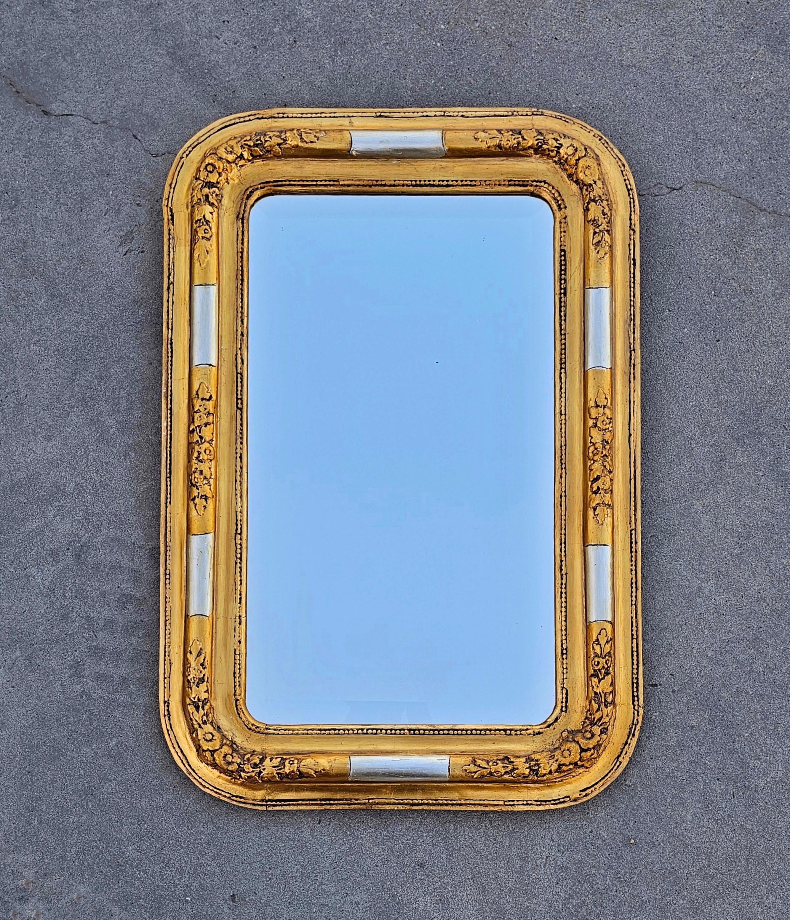 In this listing you will find a gorgeous, large and rare Biedermeier Mirror with gilt wood frame and faceted mirror glass. It features a rectangular shape with rounded corners and floral decorative carvings. The mirror is faceted. Made in Austria