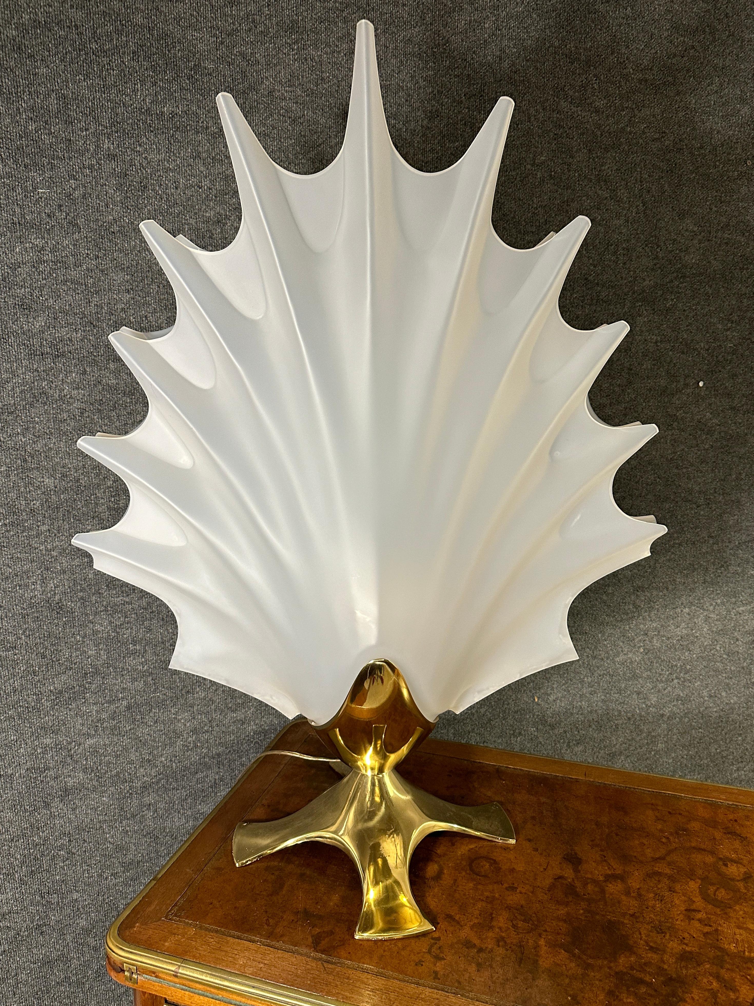 This Large and Rare Lucite Sea Shell Roger Rougier Lamp is an iconic piece. Its striking design is fashioned from acrylic and looks like frosted Opalin.
Resting upon a solid brass foot, the top acrylic shell mirrors the translucence of Opaline with