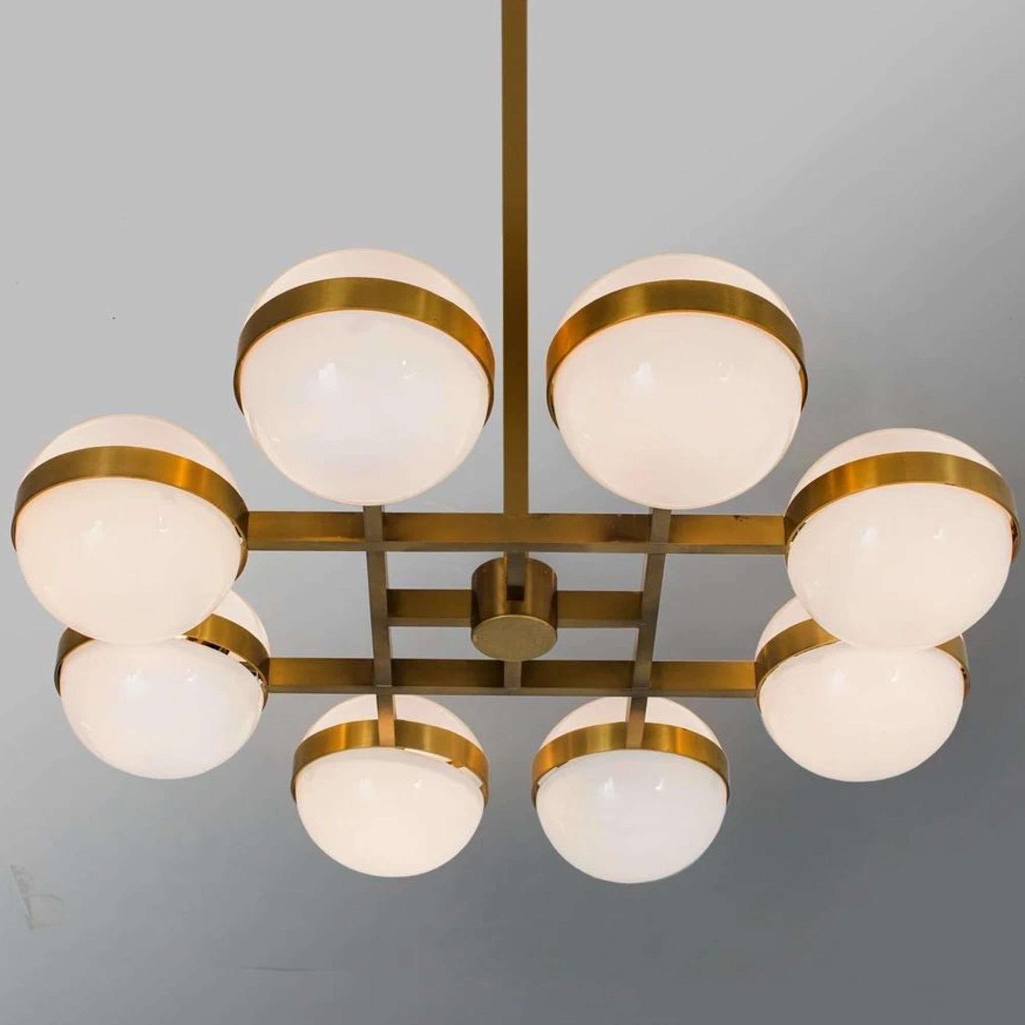 Spectacular pendant model 961-802, designed by Heikki Turunen, manufactured by Orno Oy, 1970s. Brass frame with milk glass shades. 
Good vintage condition, minor patina consistent with age and use. 
Measurements:
diameter 112 cm, shade diameter 25