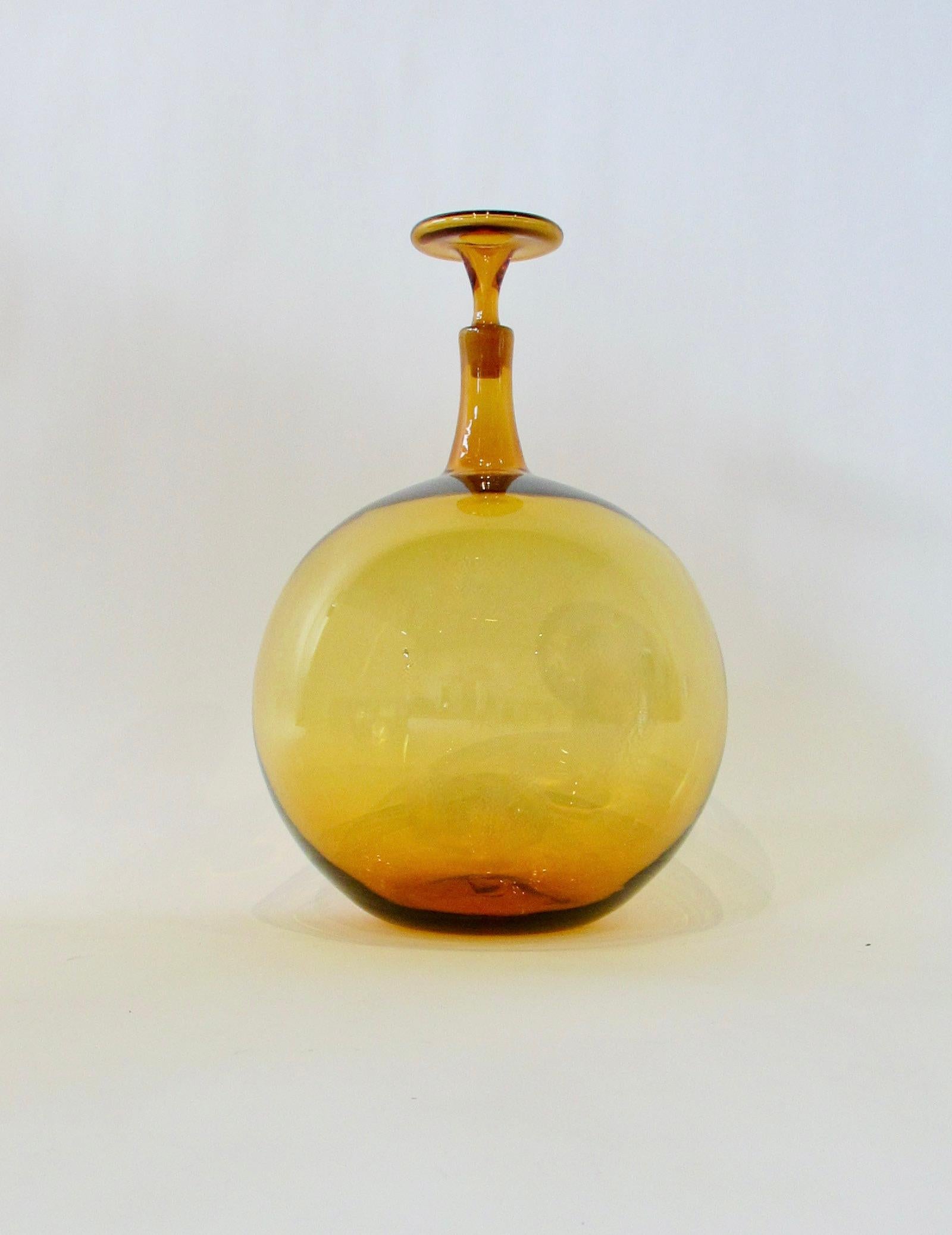 Glass Large and scarce amber tone ball shaped Blenko bottle with stopper For Sale