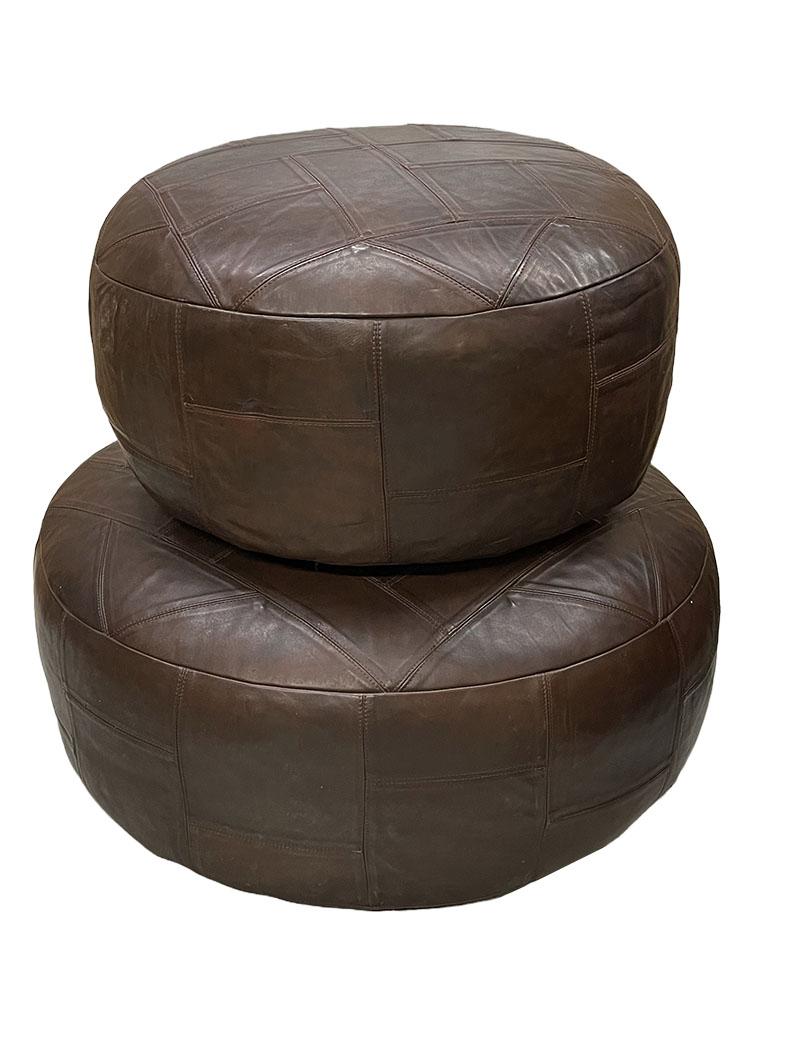 Large and small brown leather poufs, 1970s

2 identical poufs in 2 different sizes of 80 cm round and 60 cm round. Beautifully sturdy padded poufs in brown stitched leather. The leather is stitched together in sections in the shape of a triangle,