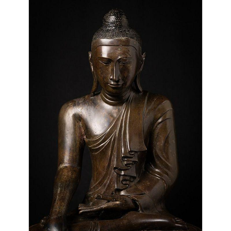 Material: bronze
75 cm high 
60,5 cm wide and 40 cm deep
Weight: 71.65 kgs
Mandalay style
Bhumisparsha mudra
Originating from Burma
19th Century
With inscriptions in the base.

