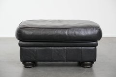 Large and timeless black ottoman made of cowhide leather in English style