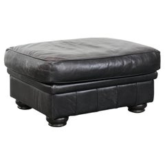Large and timeless black ottoman made of cowhide leather in English style