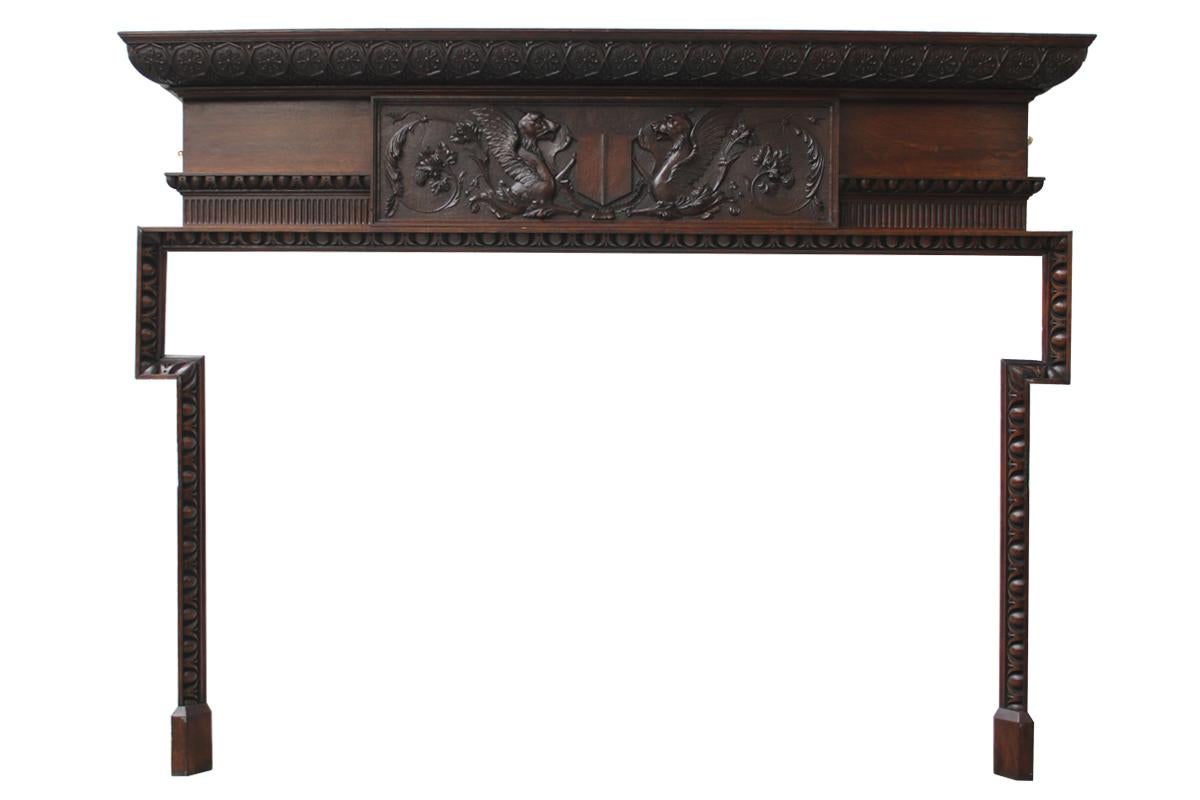 Large and unusual antique late Victorian carved oak fireplace surround in the 18th century manner with deeply carved egg and dart molded slender legs with dog leg moldings supporting a deep frieze with further egg and dart and fluted moldings