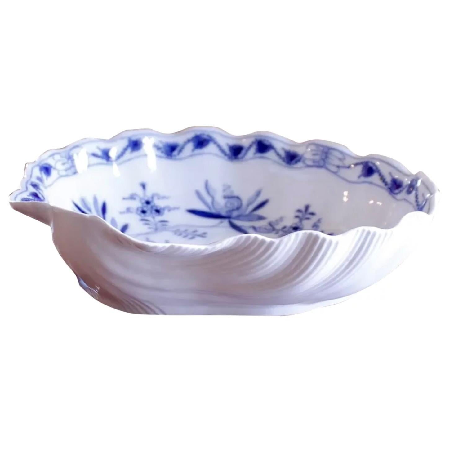 A deep and finely articulated ribbed scallop shaped early 19th century serving bowl in the pattern known as Blue Onion, which originated at the Meissen factory in Saxony in 1740, a European version in cobalt and white of popular Chinese porcelain