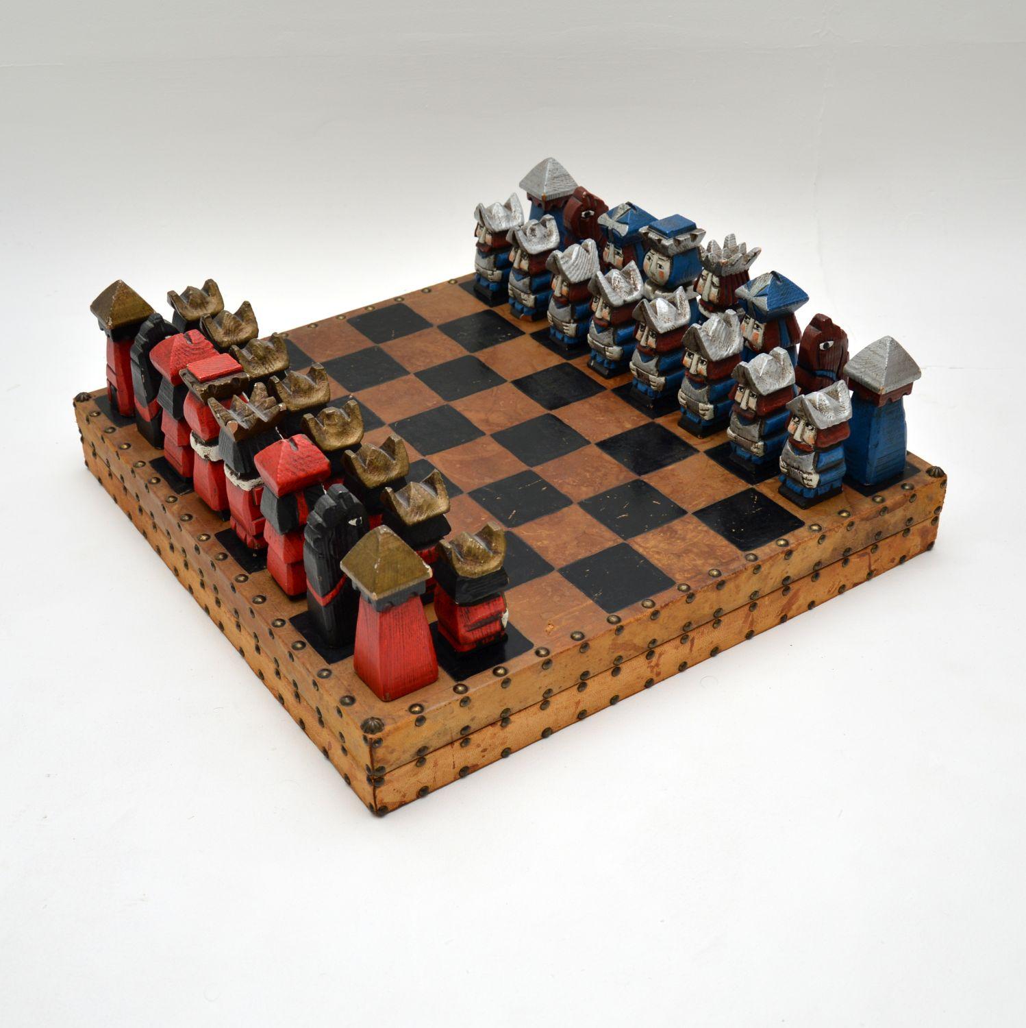 A huge and amazing vintage leather bound chess board with carved wooden figures, probably the most unusual chess set you will see! This was most likely made in continental Europe, it dates from around the 1960’s.

The board is leather bound and