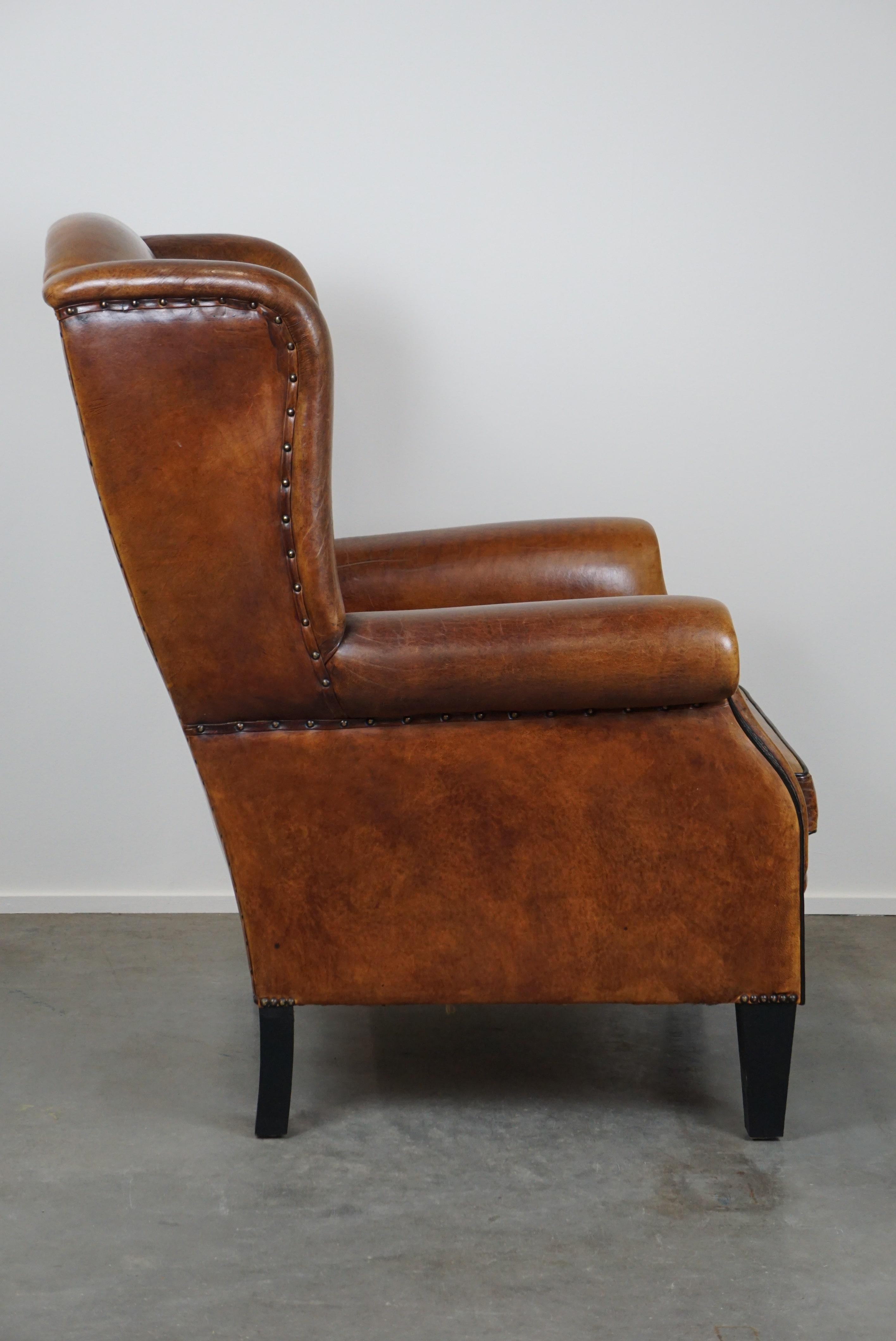 Romantic Large and very comfortable wingback armchair made of sheep leather For Sale