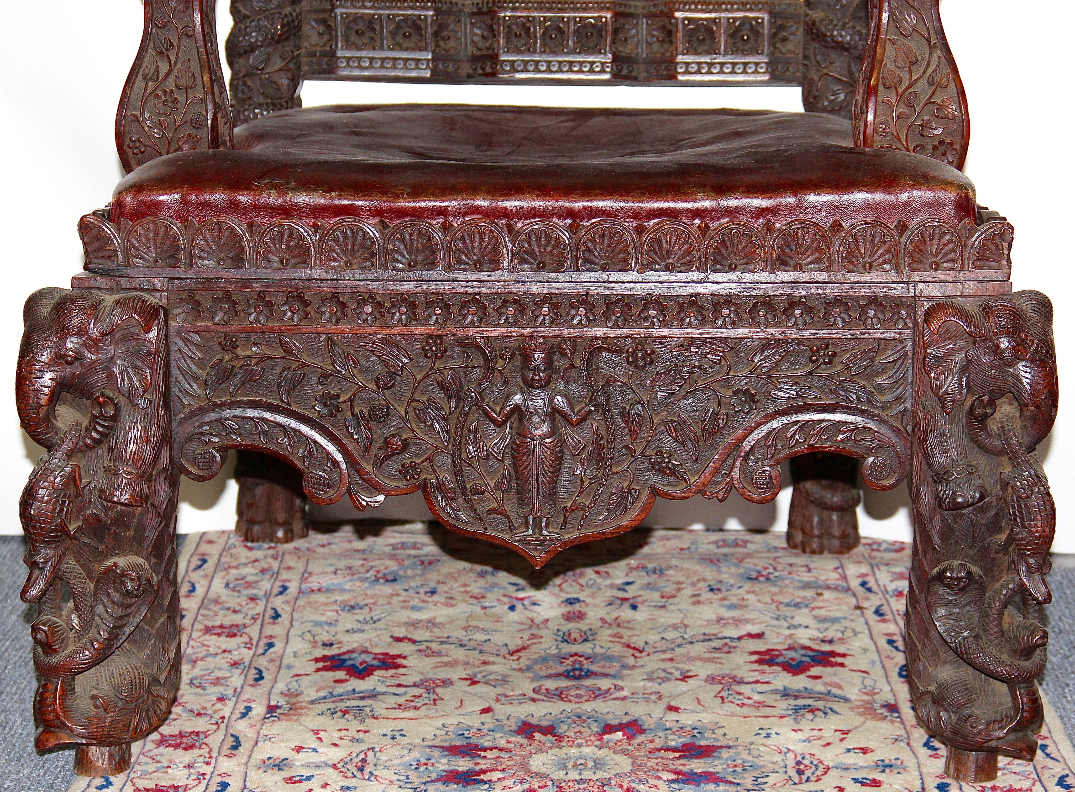 Large, massive and very decorative antique throne chair.
Carefully and in detail carved.

At first glance, the armchair has Asian elements. 
The lion heads and the coat of arms, however, clearly have a European character.
Therefore, the