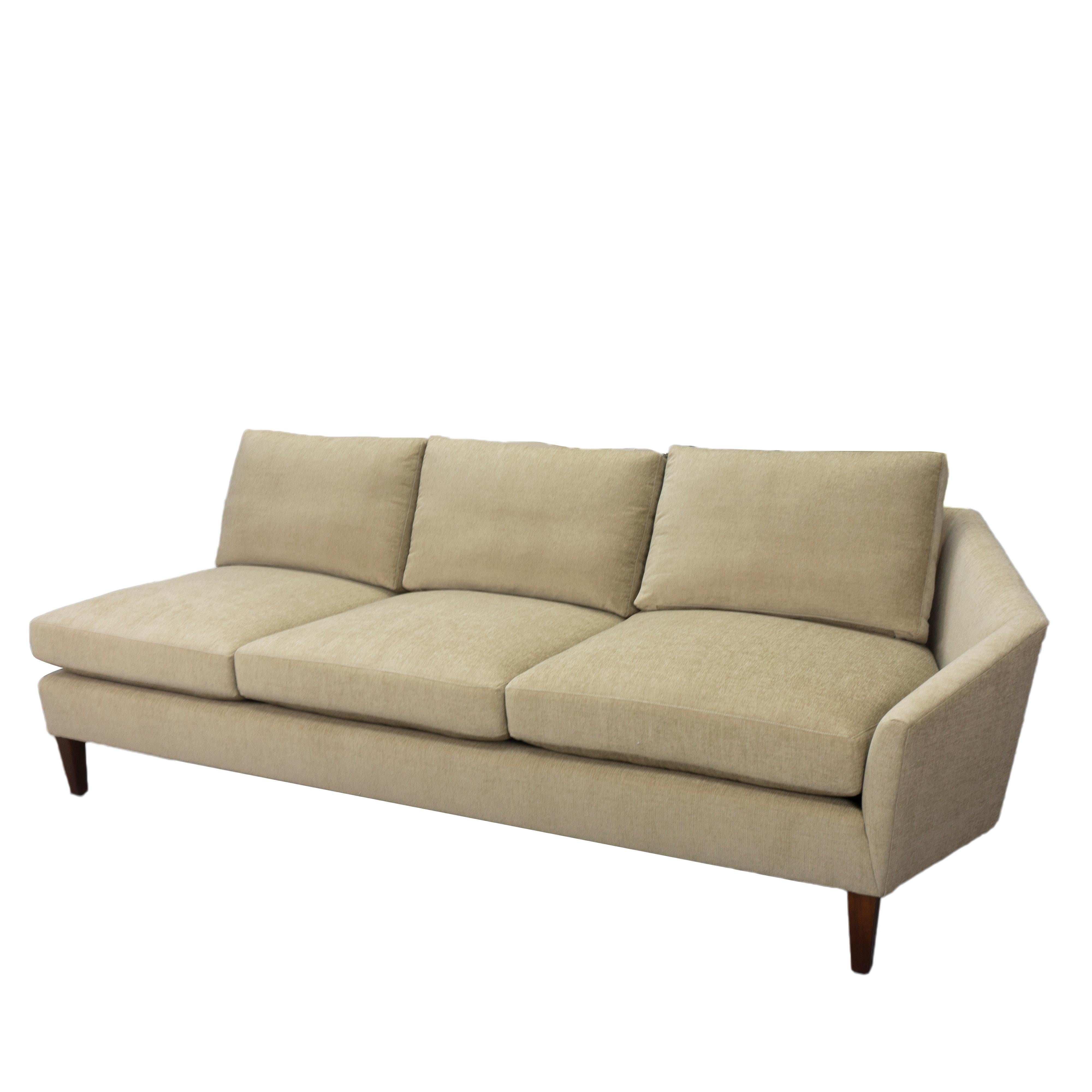 About This Piece
This customizable sectional sofa features pitched arms that point outward as they slope down, creating a welcoming look and the illusion of a low back rail. The cushions feature top-stitching for a custom tailored look. Our