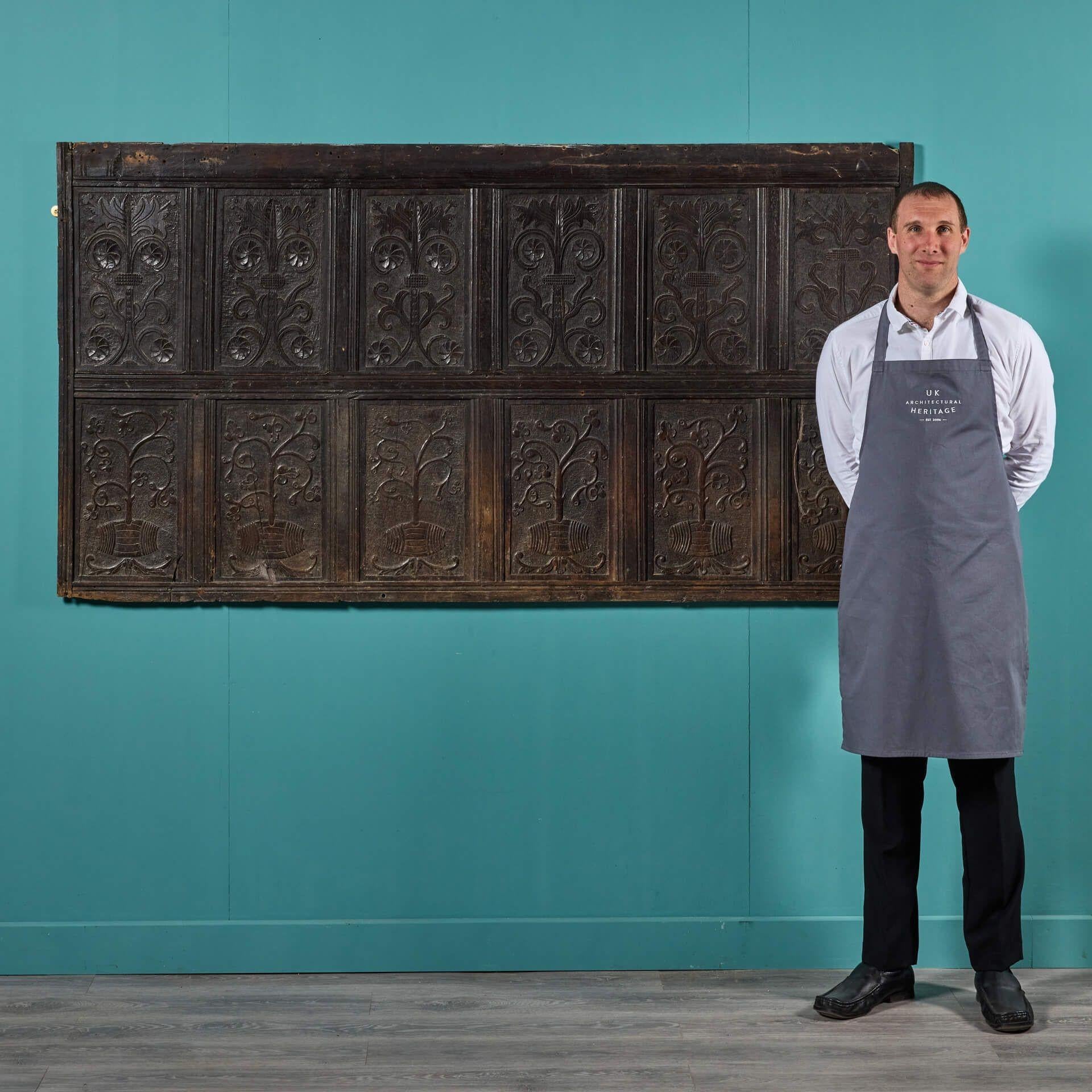 A large antique 17th century carved oak panel. Dating to circa 1650, this oak panel displays exceptional hand-carved decoration featuring carvings of barrels growing stylised plants.

This is thought to be an ode to the expeditions that took place