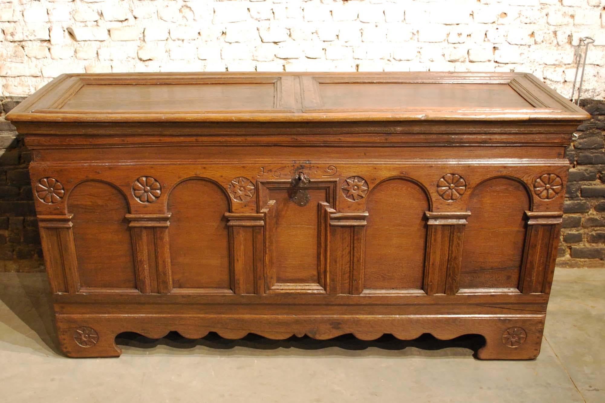 A beautiful warm brown Renaissance chest or coffer that was made in 1669 in the Netherlands as it is dated of the front. 
The front has hand carved geometric ornaments and arched panels typical for the Renaissance style. The chest has its original
