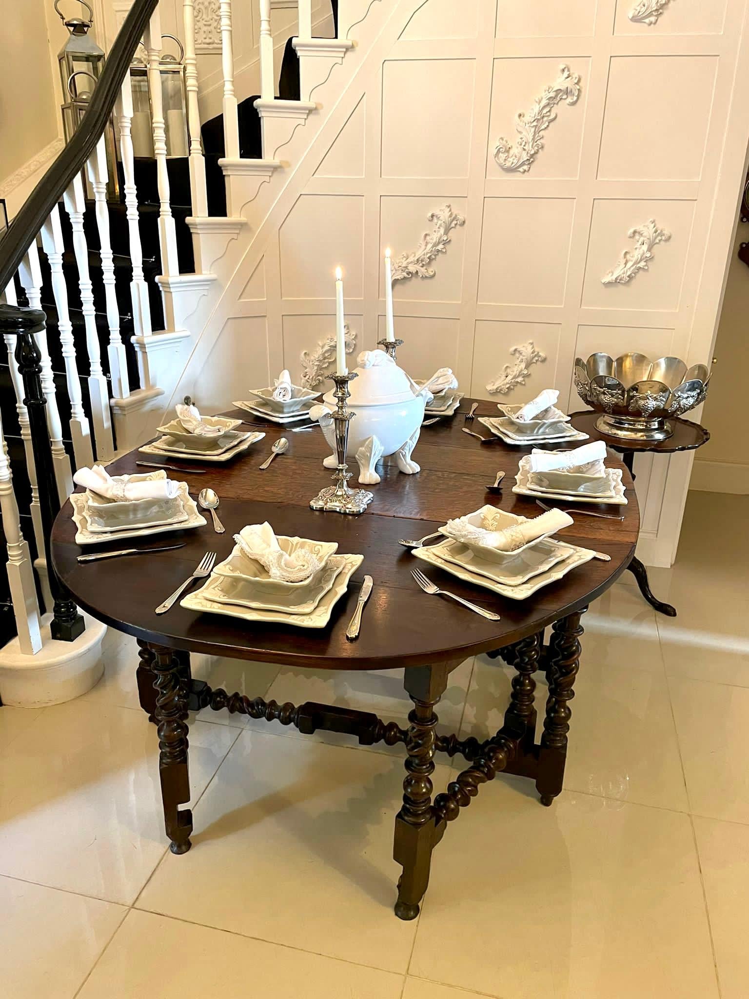 Large antique 17th century quality oak double gate leg table having a large quality oak top with two drop leaves supported by bobbin turned and barley twist ends with bobbin turned and barley twist double gate legs united by bobbin turned and barley