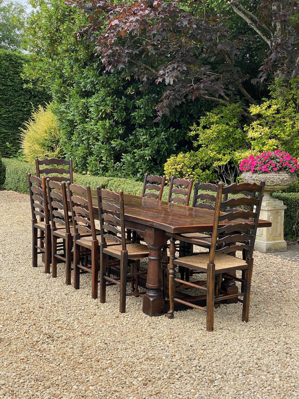 Large antique 18th century design oak refectory dining table & twelve chairs 9 foot

Magnificent large 9ft long antique 18th century design solid oak refectory dining table with twelve matching oak ladder back rush seated dining chairs dating to