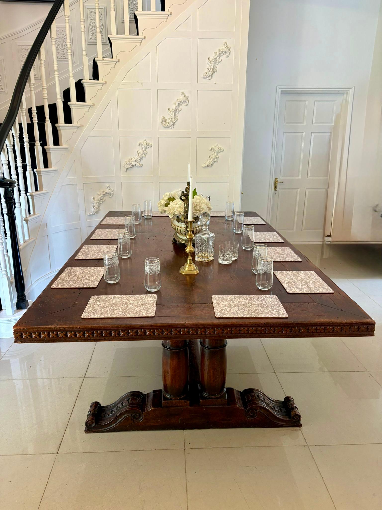 Large antique 19th century 12 seater quality oak refectory dining table having a large quality oak rectangular shaped top with a lovely carved edge supported by 4 turned pedestal columns standing on carved scrolled feet united by an oak