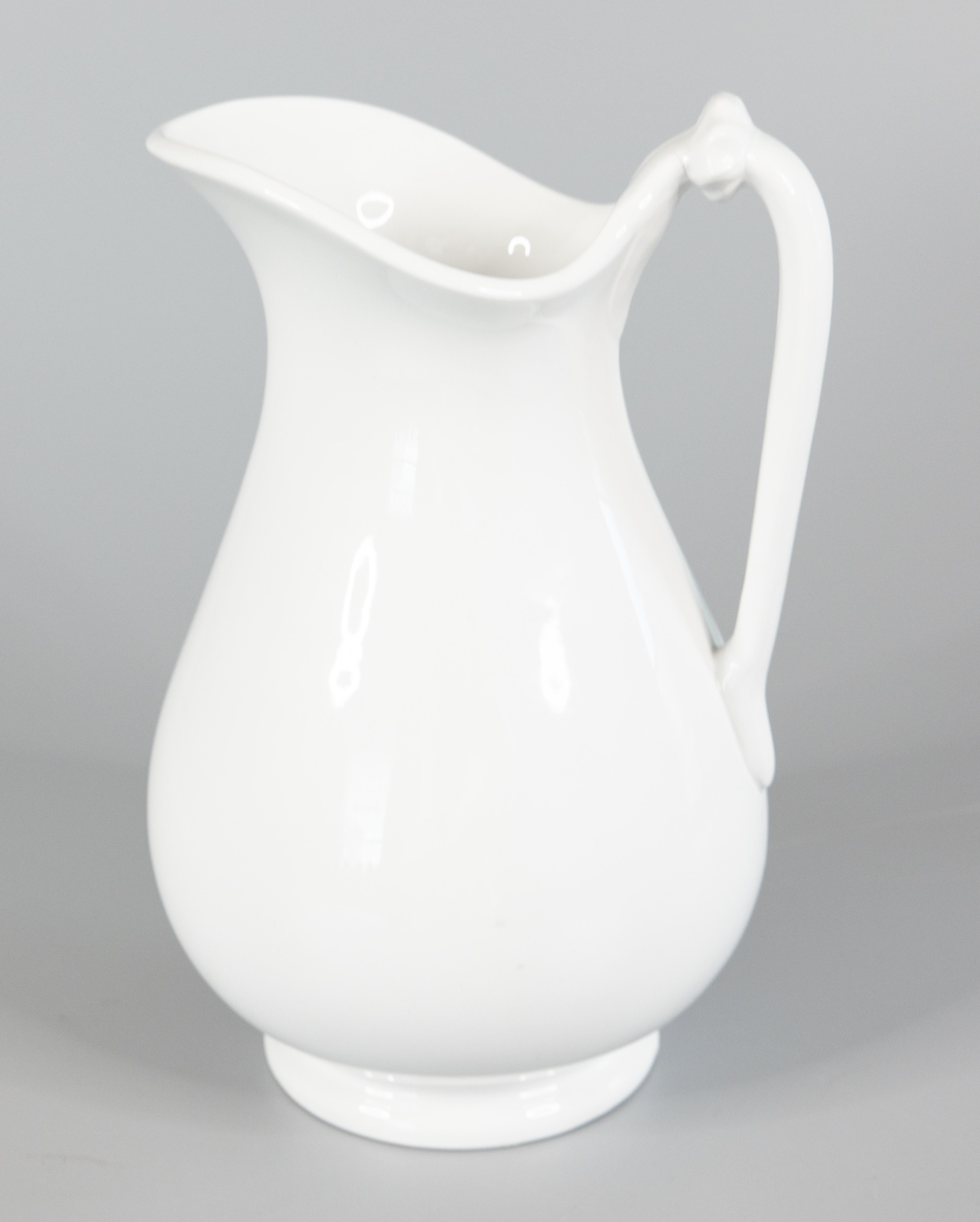 A lovely antique English white ironstone pitcher by T. & R. Boote, circa 1870. Maker's mark on the bottom with raised registration diamond. It's a nice large size measuring 12 inches tall. This classic and timeless pitcher has a wonderful simple