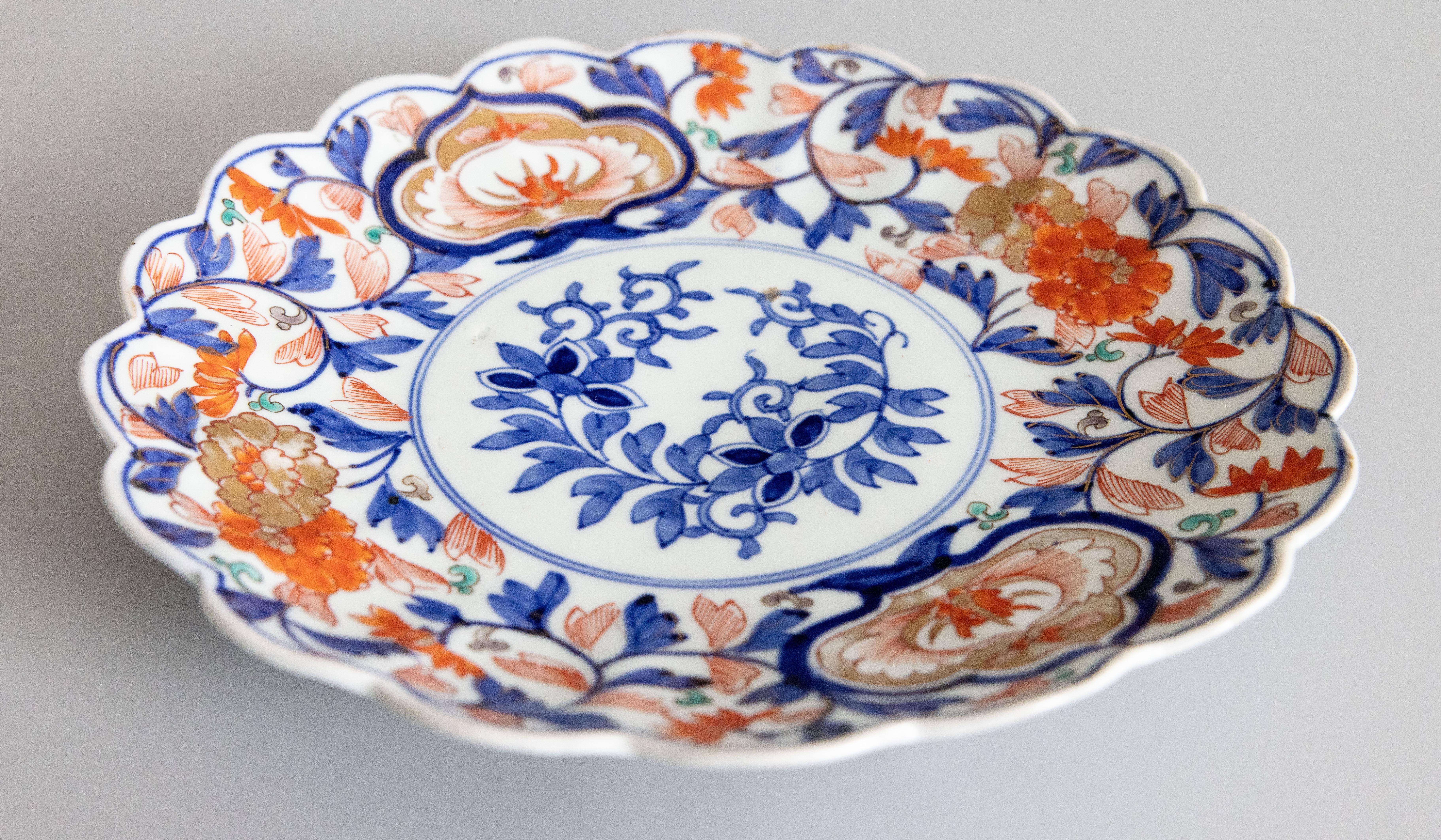 Un très bel exemple d'une grande assiette Imari antique, 19ème siècle, avec un bord festonné. Des oranges et des bleus vibrants avec des touches de vert. Le design multicolore représente des motifs japonais traditionnels, mettant en valeur
