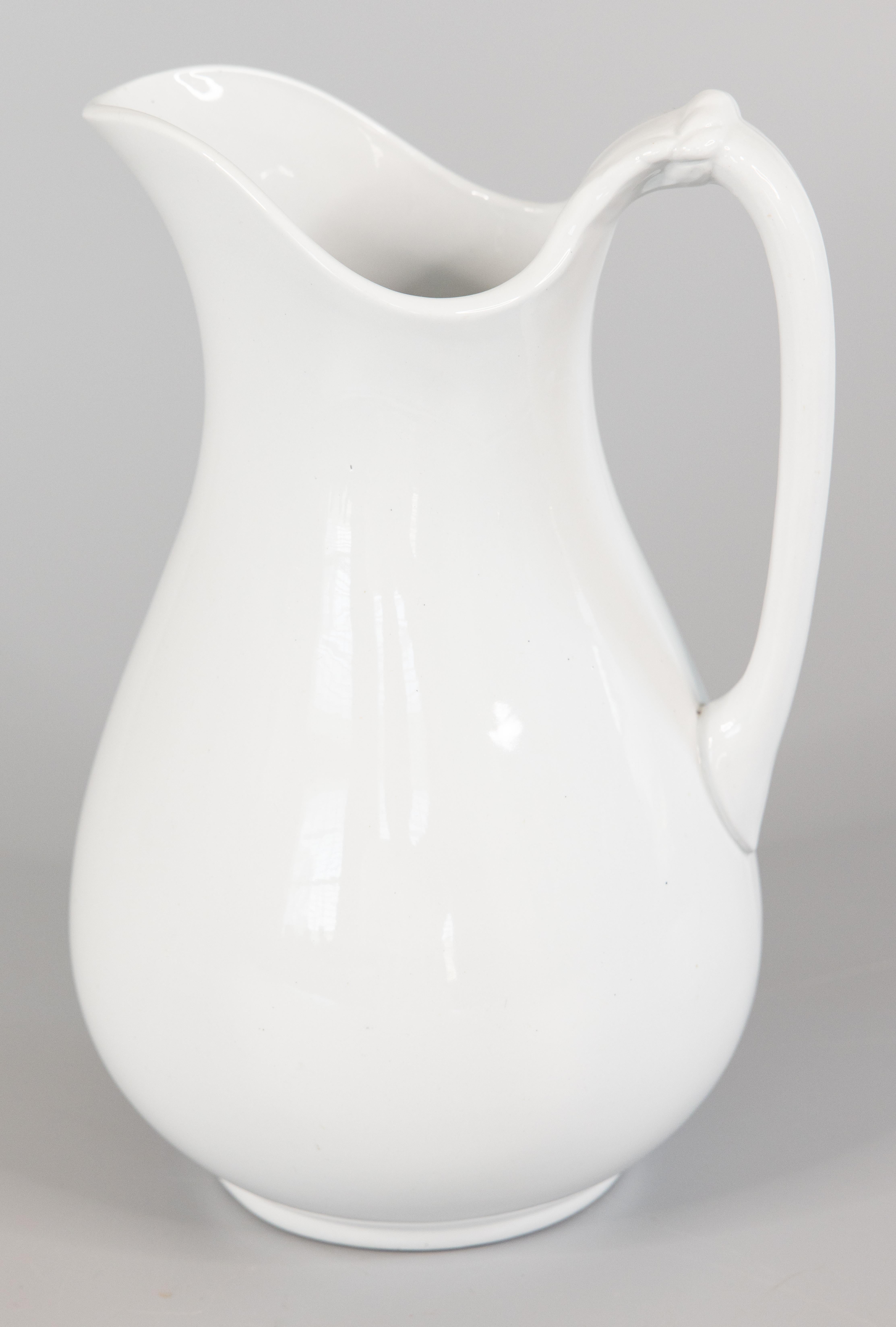 A lovely antique English white ironstone pitcher by J. & G. Meakin, circa 1890. Maker's mark on the bottom. It's a nice large size measuring 12 inches tall. This classic and timeless pitcher has a wonderful simple shape with clean lines, perfect for