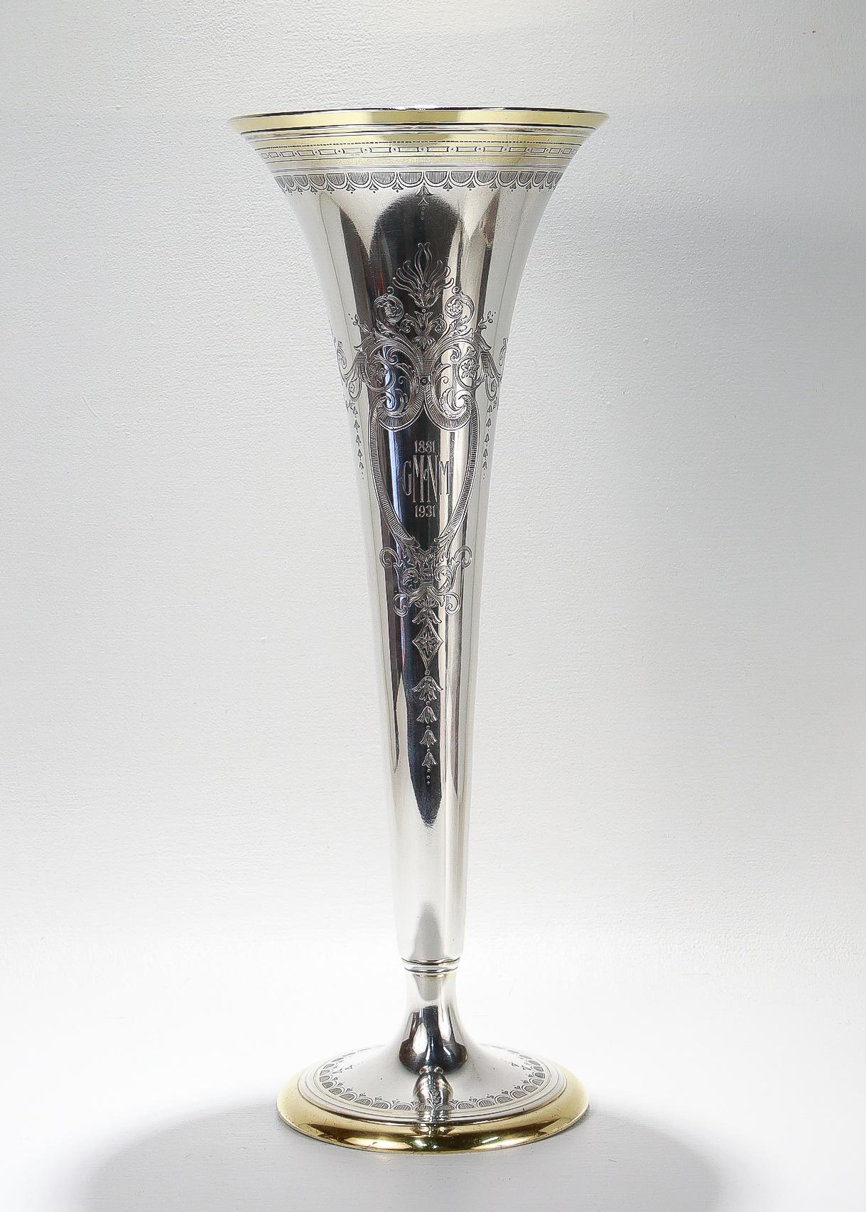 
A fine antique large trumpet form silver flower vase. 

By Tiffany & Co.

In sterling silver.

Decorated throughout with intricate engraving and with a gold wash to both the footrim and the interior of the vase.

With engravings to both sides.