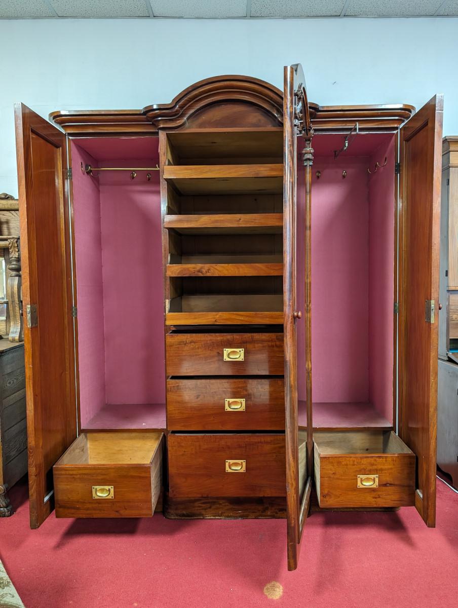 Mid- late 19th century, Mahogany case, Gorgeous Flaming Mahogany front, Arched top, 3 Doors open to ample storage, Center door has a mirrored front and opens to several storage drawers, Left door has a hanging rod, hooks, and a deep bottom drawers,