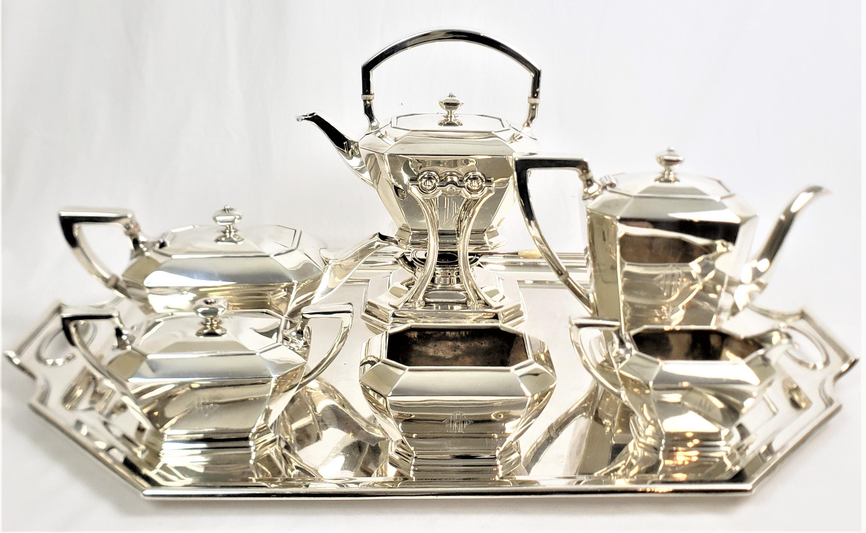This large and substantial tea set was made by the well known Black, Starr & Frost Silver Company of the United States and dates to approximately 1920 and done in the period Art Deco style. The entire seven piece set is composed of sterling silver