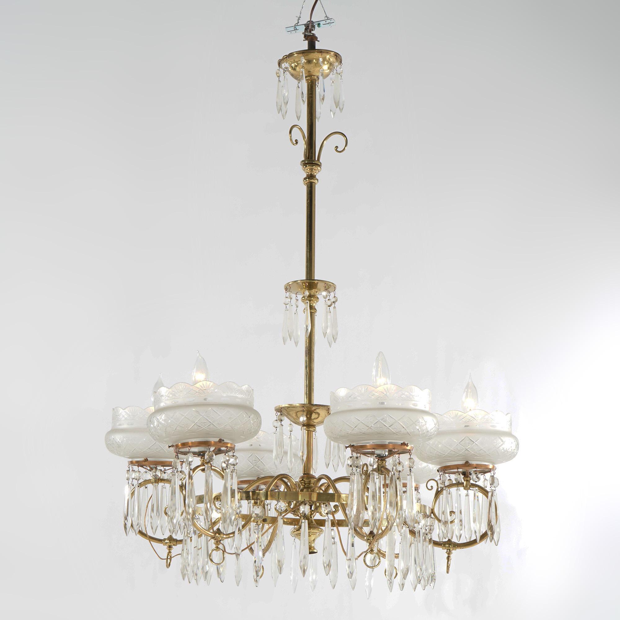 An oversized antique Aesthetic Movement chandelier offers brass frame with six scroll form arms terminating in candle lights with cut glass bowl form shades, hanging cut crystals throughout, gas converted to electric, circa 1870

Measures - 44.5