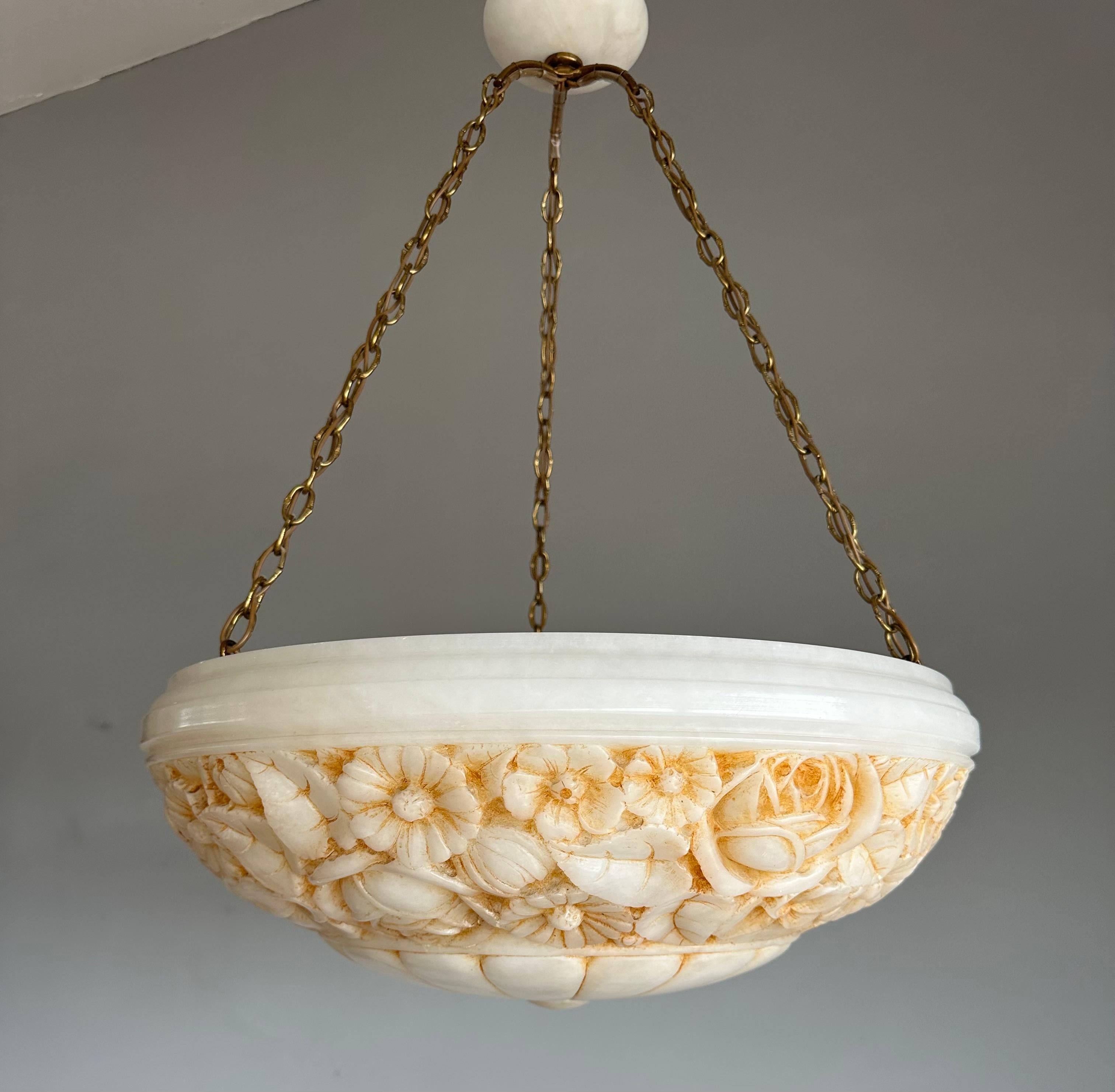 Awesome Arts & Crafts, 3-light alabaster chandelier with awesome carvings.

Thanks to its large size, its superbly handcarved rose and flower patterns AND its superb condition this museum worthy alabaster chandelier will light up both your days and