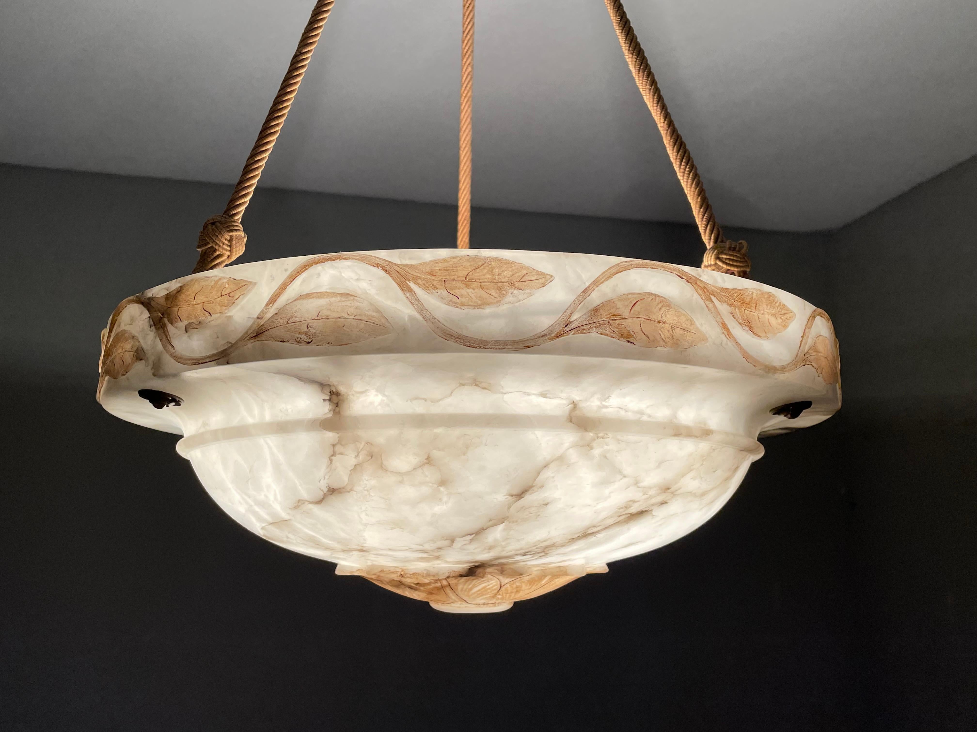 Top class, Arts & Crafts era chandelier with a unique alabaster shade and perfect canopy.

Thanks to its large size, its unique handcarved design and mint condition this alabaster chandelier will light up both your days and evenings. What makes this