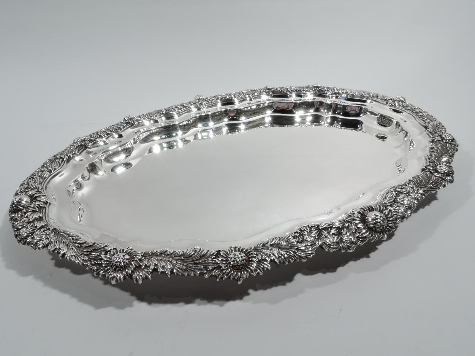 American Chrysanthemum sterling silver tray, ca 1910. Scroll-shaped oval well and irregular rim comprising dense and overlapping flower heads and foliage. A gorgeous piece in the historic pattern. Marked “Sterling” and “20 IN”. Tiffany quality but