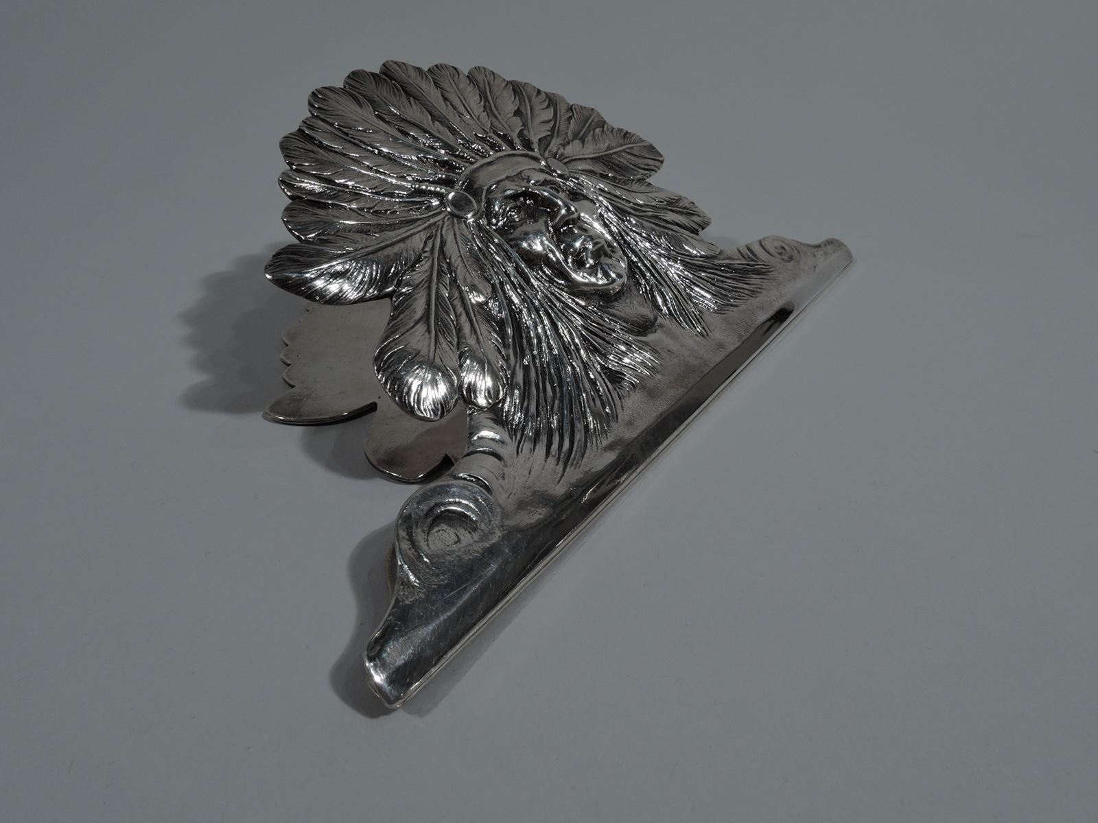 Large American sterling silver novelty paper clip, circa 1900. Clip front in form of Indian chief head with feathered headdress and stern visage. Back plain. Adds a touch of adventure to bill paying night. Stamped “Sterling”. Weight: 8.5 troy ounces.