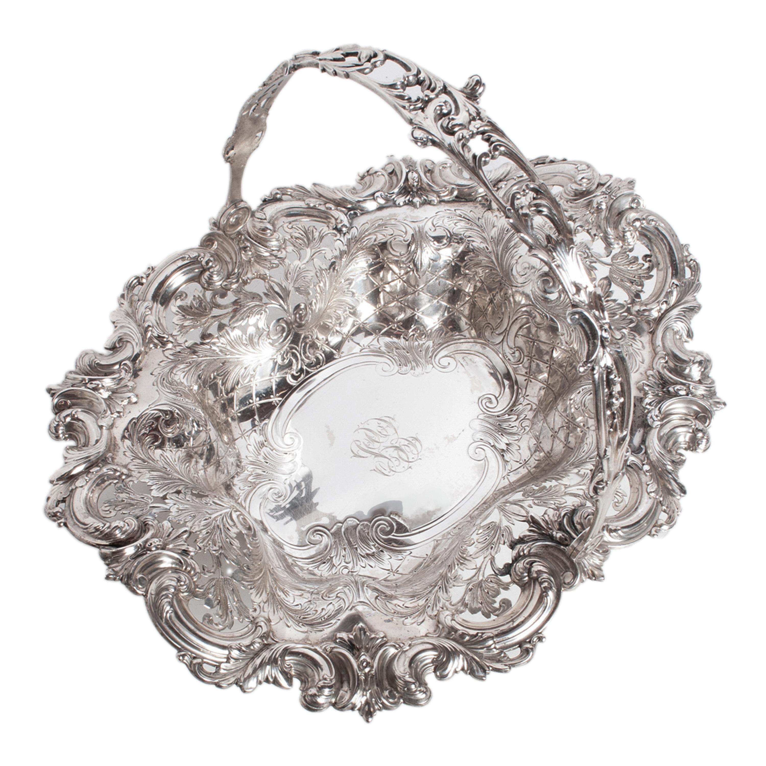 A fine & large antique American Victorian Classical solid sterling silver engraved & Repoussé handled basket, circa 1890. Retailed by Tiffany & Co., New York. 
This very beautiful large sterling silver basket having a hinged handle with pierced work